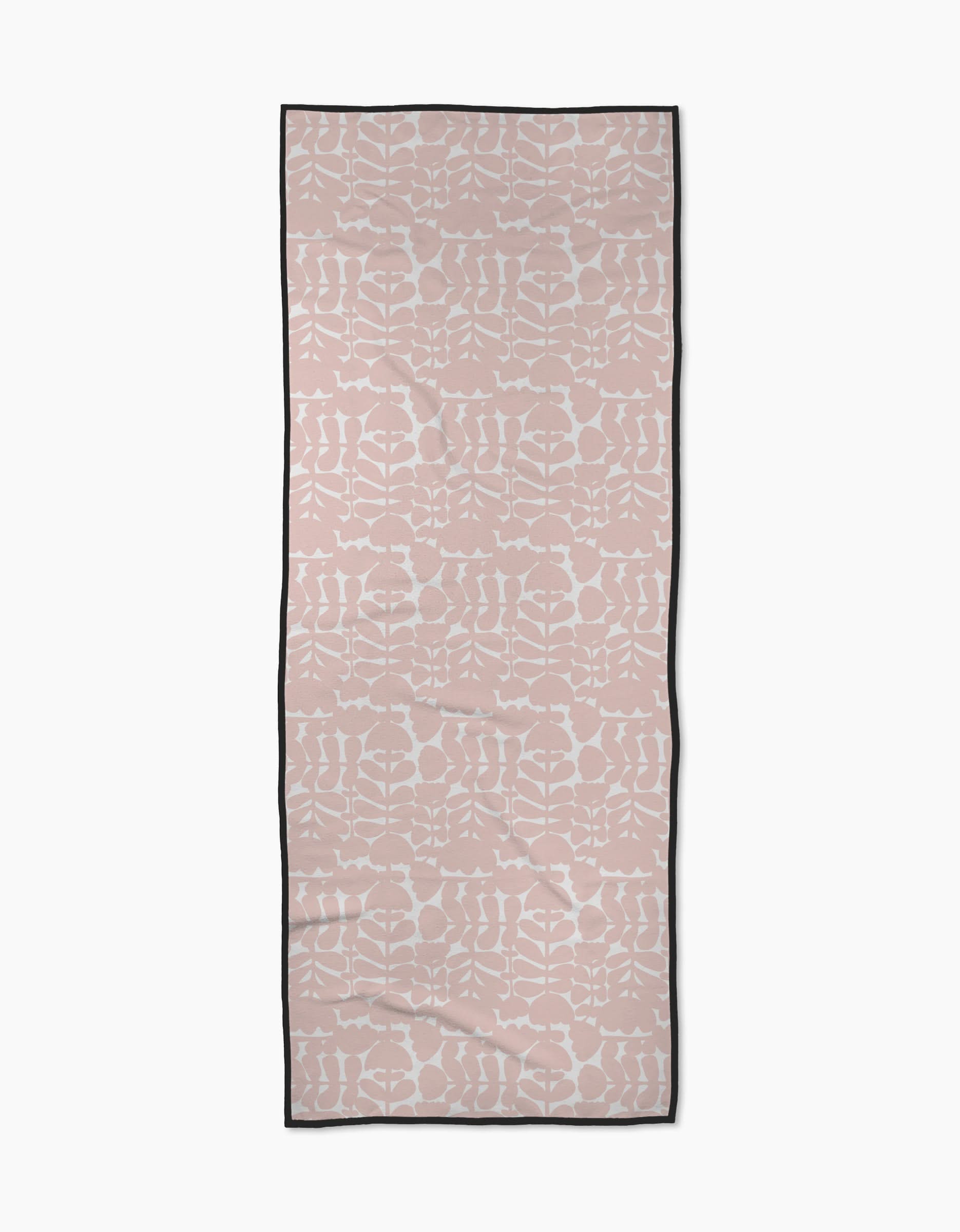 The Pink Scandi Flowers yoga towel by Katie OShea is rectangular, light pink with a white symmetrical floral pattern and a thin black border, shown flat on a white background.