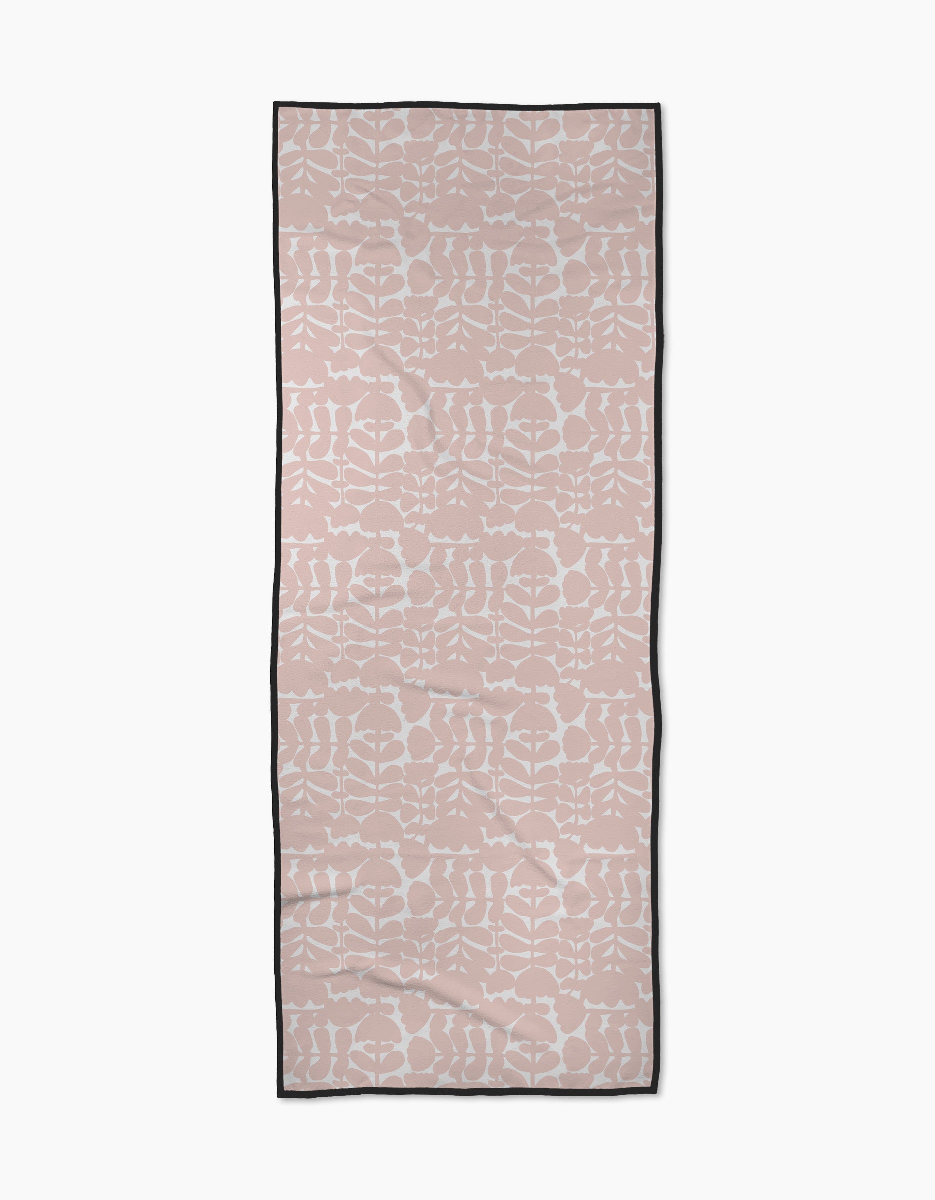 The Pink Scandi Flowers yoga towel by Katie OShea is rectangular, light pink with a white symmetrical floral pattern and a thin black border, shown flat on a white background.