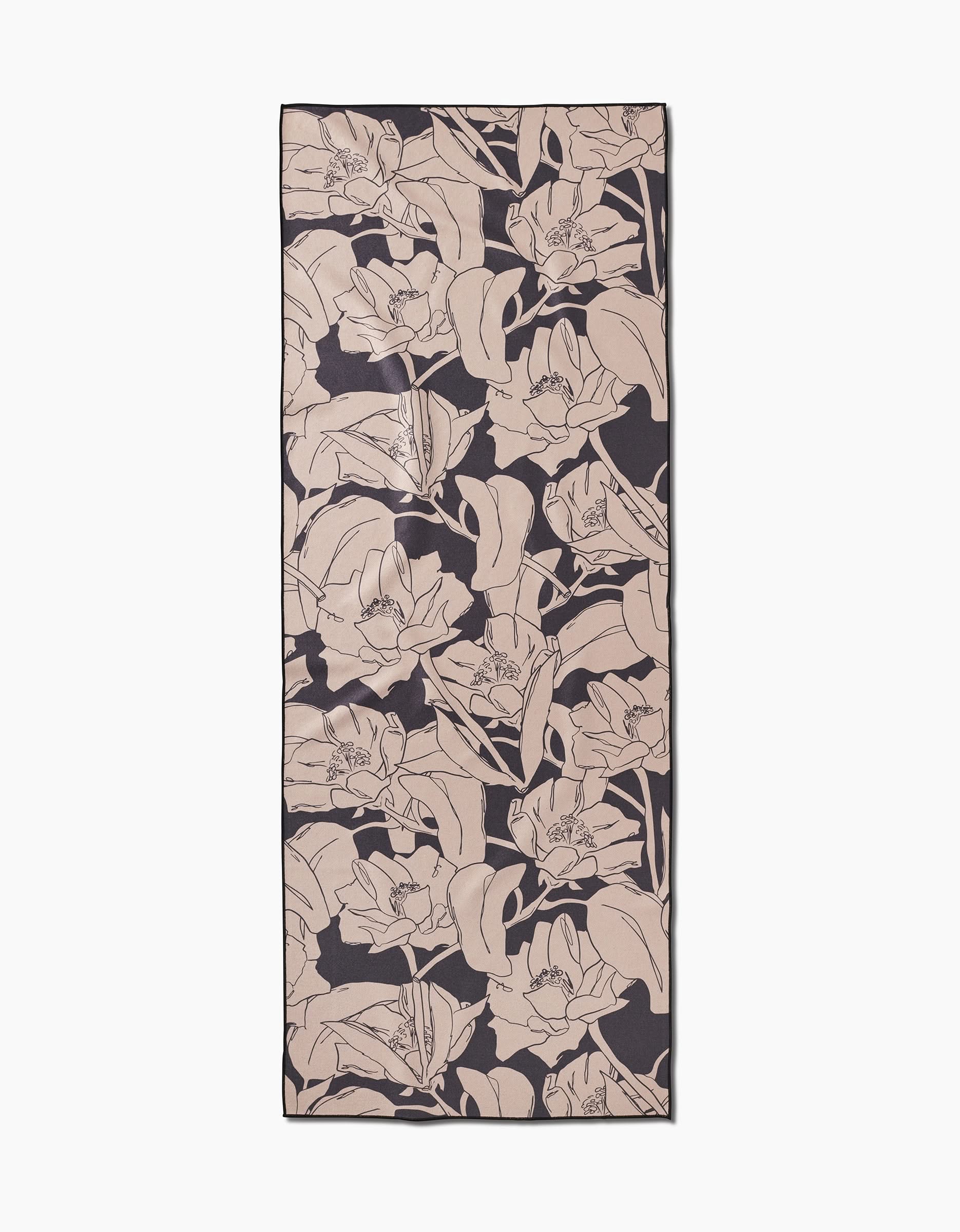 The Plant One on Me yoga towel by Aubrey Fairchild features a beige floral pattern on a dark background, offering stylish, non-slip stability for your practice with its elegant, outlined flowers and leaves in a repeating design.
