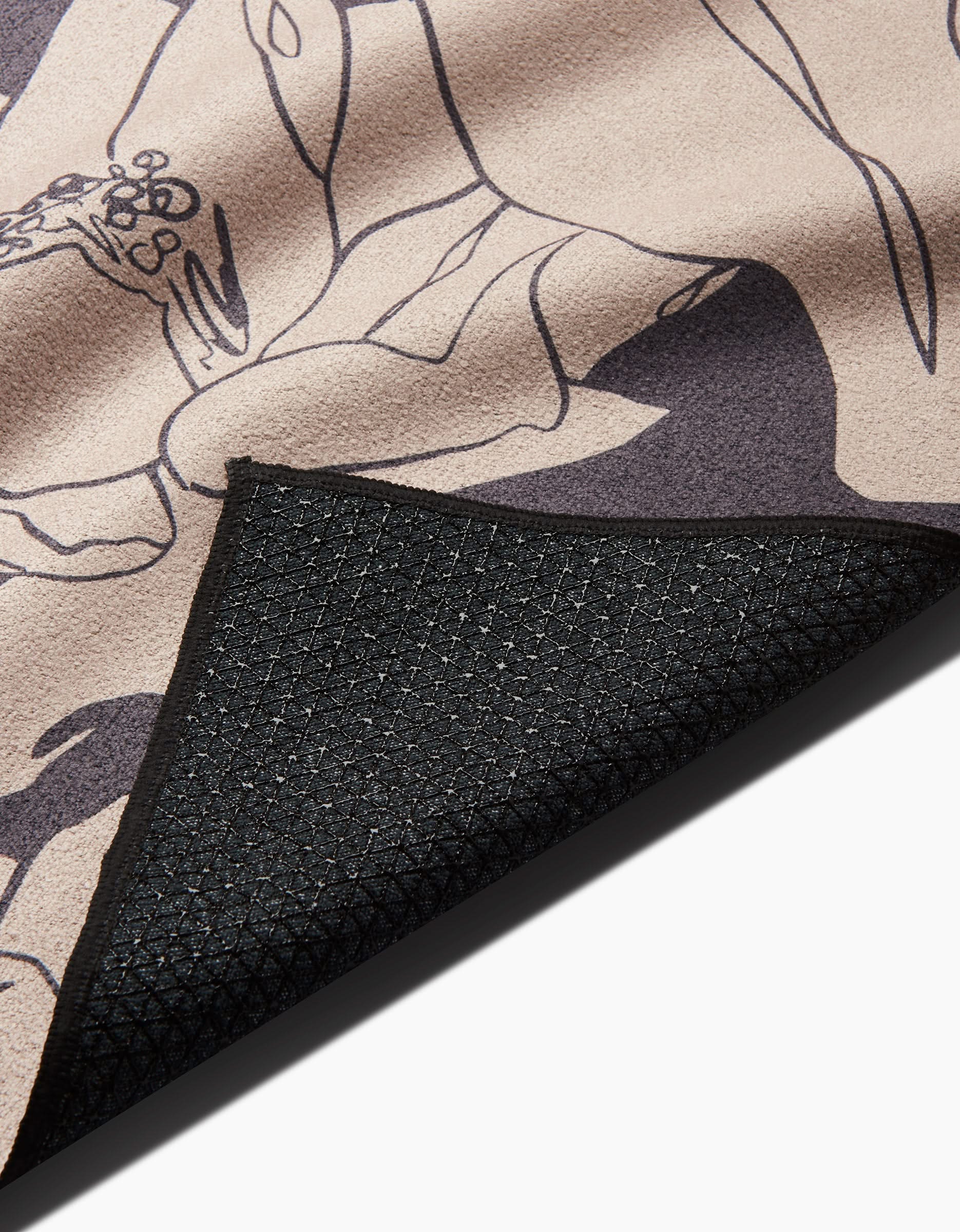 A close-up of the Plant One on Me mat by Aubrey Fairchild, showing its abstract floral top and black, textured non-slip backing, resembling a yoga towel.