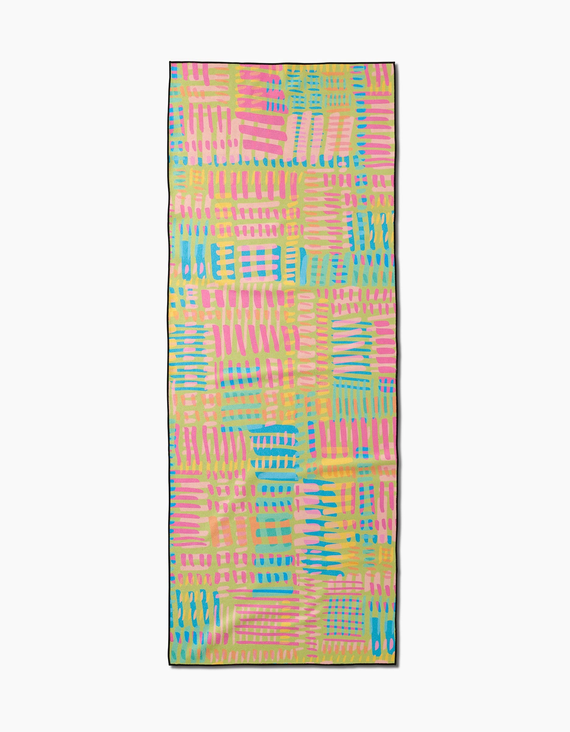 The Positive Vibes yoga towel by Sareka Unique features a colorful abstract pattern with pink, yellow, blue, and green brushstrokes on white. Made from recycled materials for eco-friendly workouts.