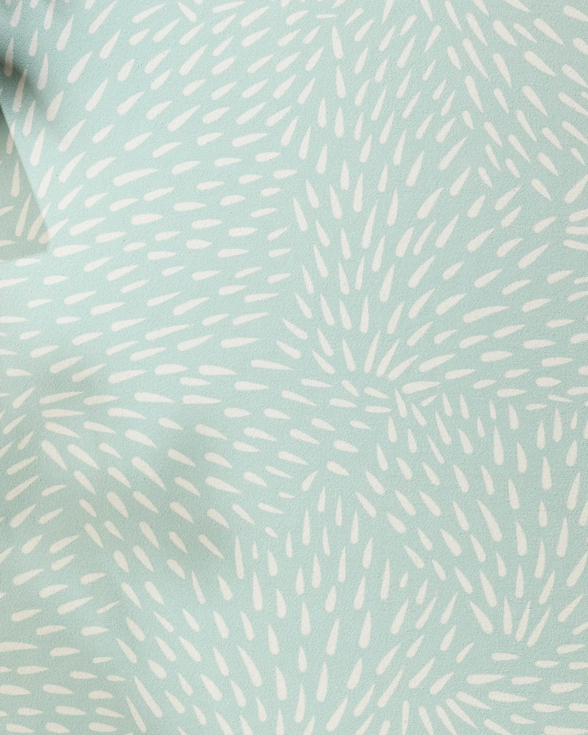 The Quill Blue yoga towel by Rebecca Woolbright features a light blue hue and a starburst pattern of small white ovals, creating movement and texture across its recycled, non-slip surface.