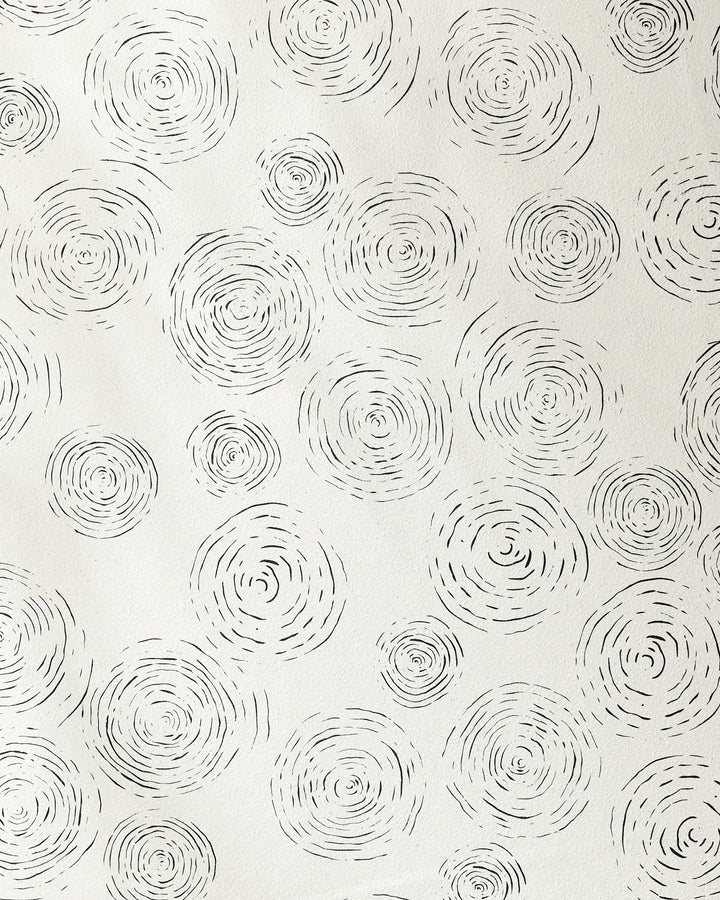 Rhythmic by GEOMETRY features hand-drawn black concentric circles on white, evoking abstract tree rings. This minimal, repeating pattern is ideal for a yoga towel with silicone grip made from recycled materials.