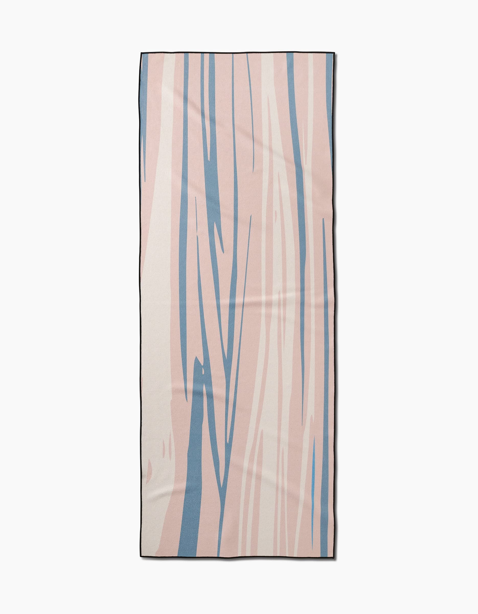 The GEOMETRY Root yoga towel is rectangular and slip-resistant, featuring an abstract design with wavy blue and light pink lines on a beige background, accented by a thin black border.