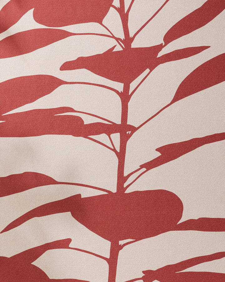 Smoketree by PrintedPlant features a red leafy plant silhouette on a beige background. Inspired by nature, this recycled yoga towel design showcases stylized leaves and branches for a calming vibe.