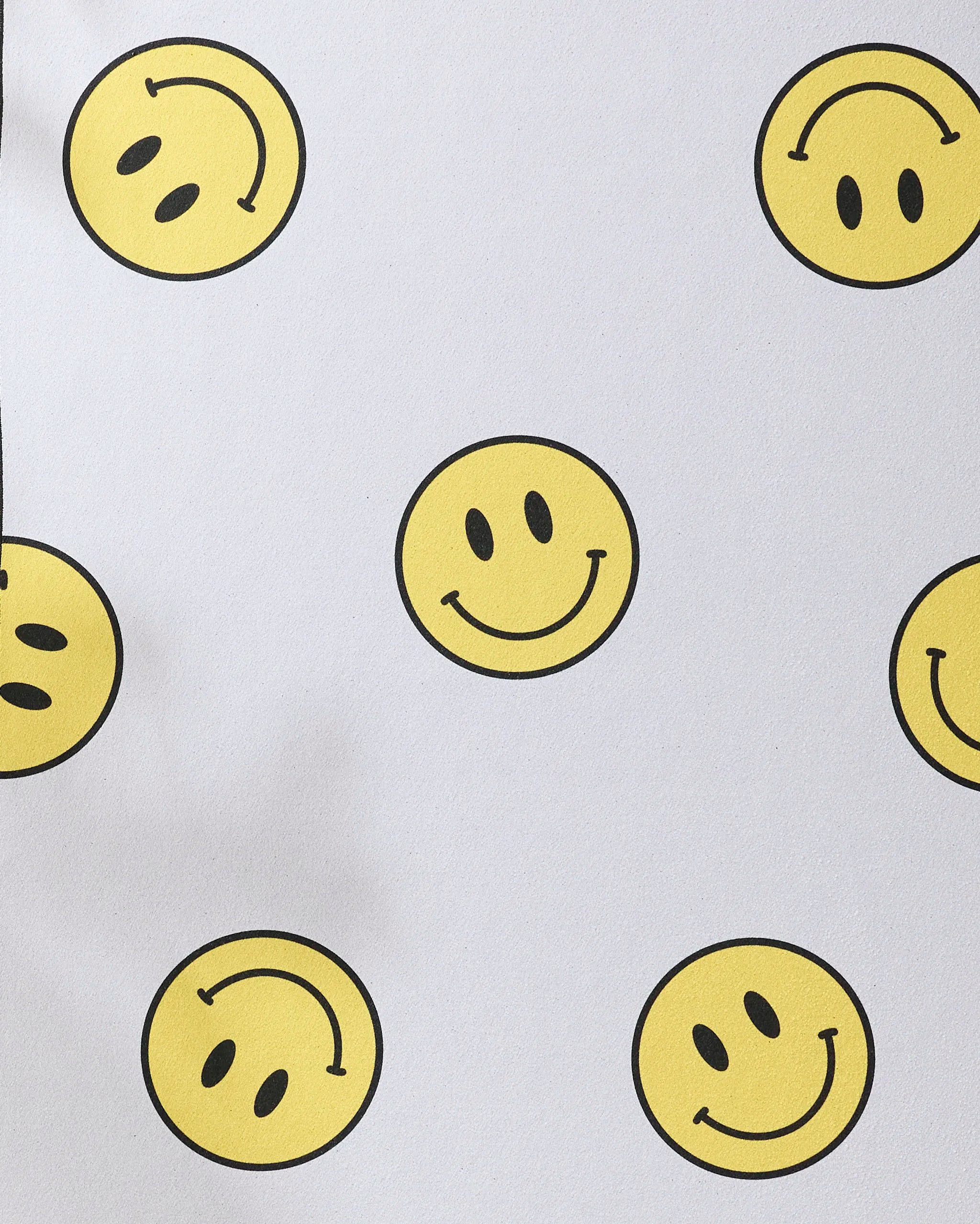 The "Soul Happy" yoga towel by Quotes by Christie features a non-slip white surface decorated with upright happy yellow smiley faces and upside-down frowning ones.