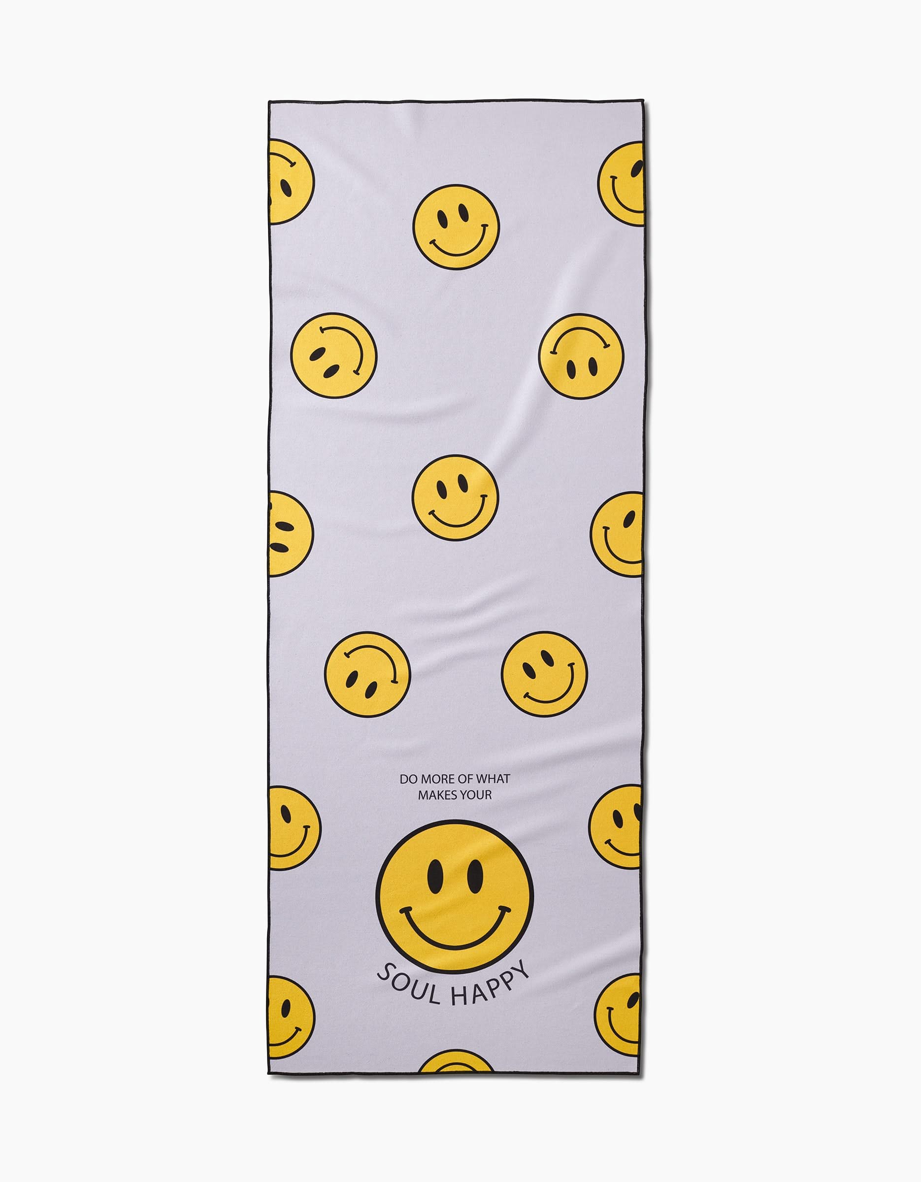 The Soul Happy yoga towel by Quotes by Christie features yellow smiley faces on a white background and the phrase “DO MORE OF WHAT MAKES YOUR SOUL HAPPY.” Made from recycled materials, this slip-resistant towel is both eco-friendly and inspiring.