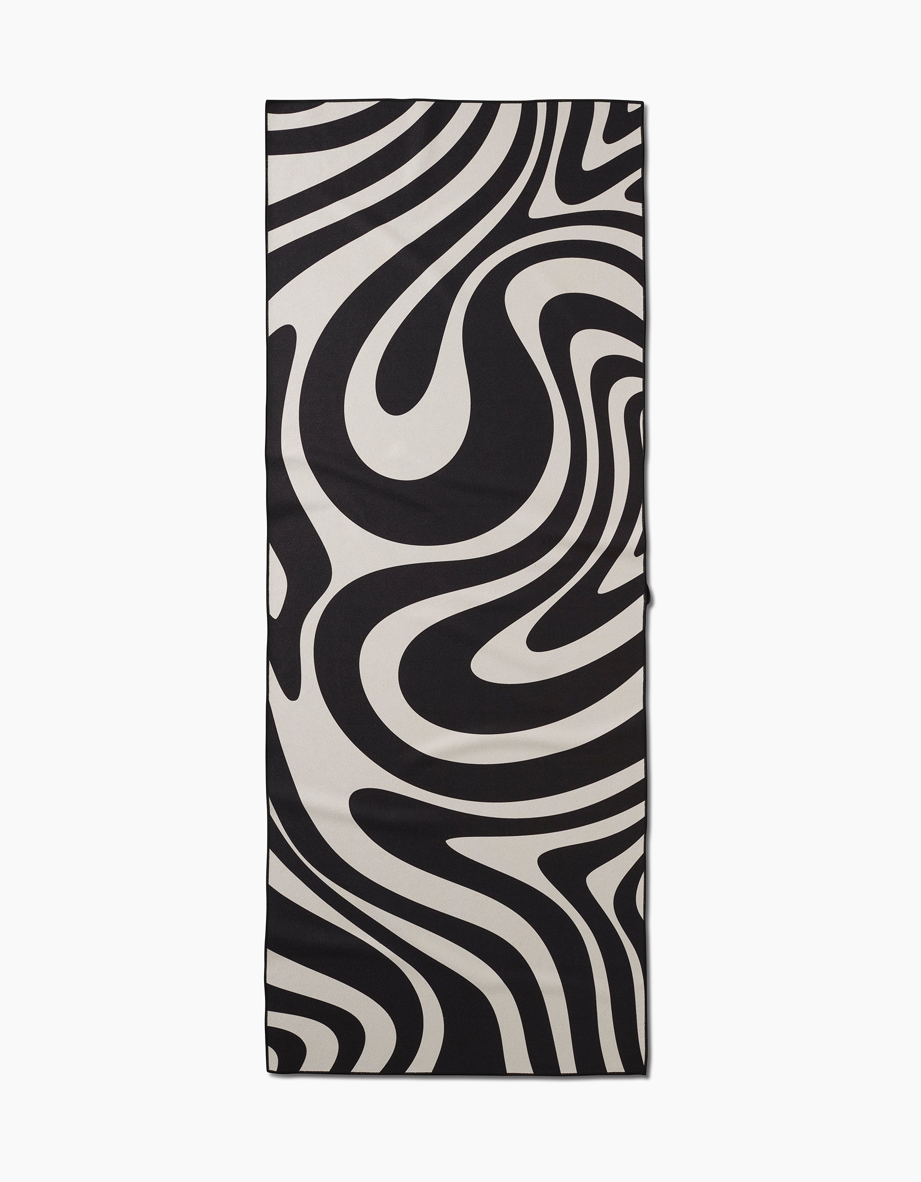 The GEOMETRY Spiral slip-resistant yoga towel is rectangular and features a bold black and white abstract swirl pattern reminiscent of wavy zebra stripes, shown laid flat on a white background.