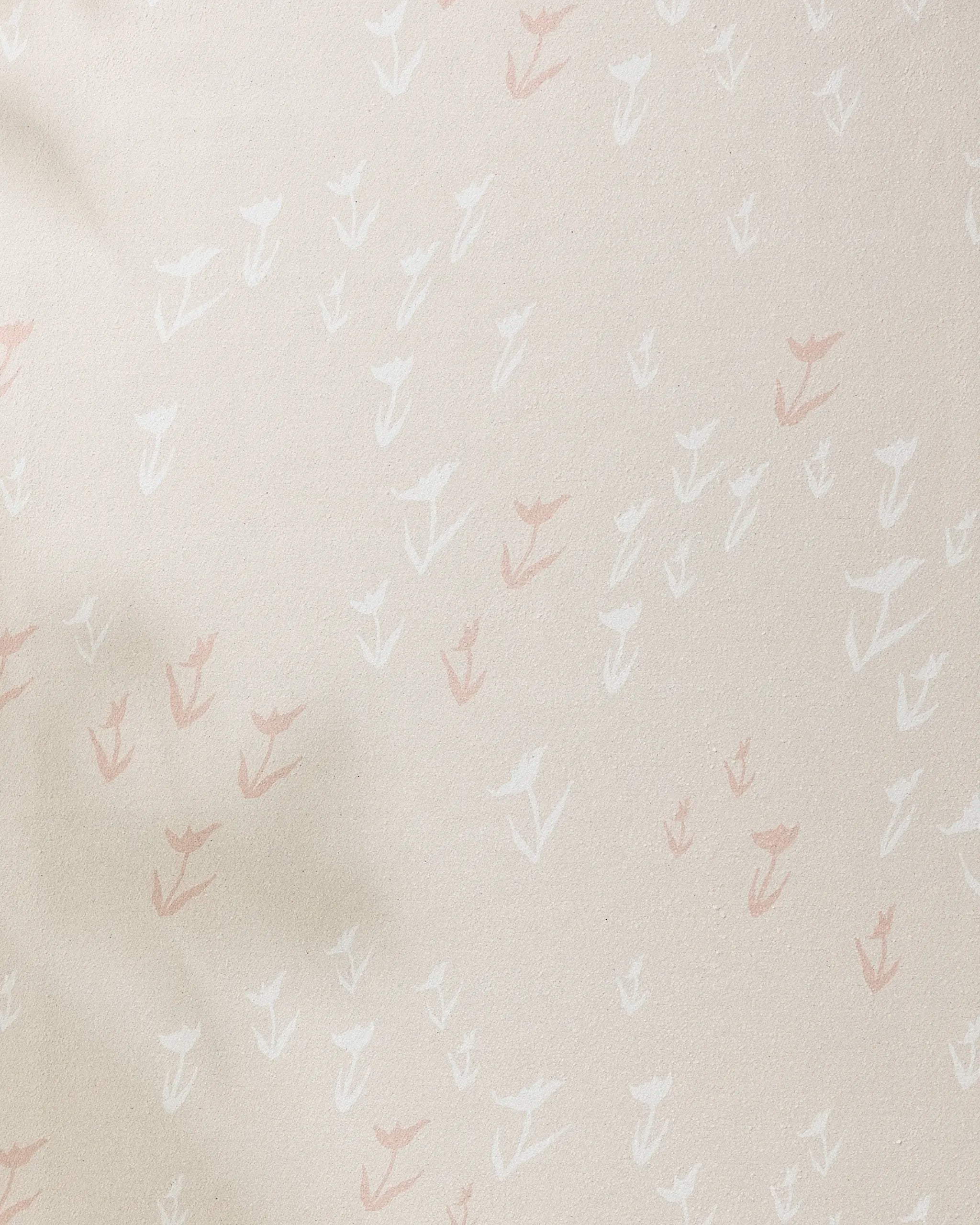 The Aubrey Fairchild "You Grow Girl" yoga towel is beige and slip-resistant, featuring a subtle pattern of small hand-drawn white and light pink flowers scattered across its surface.