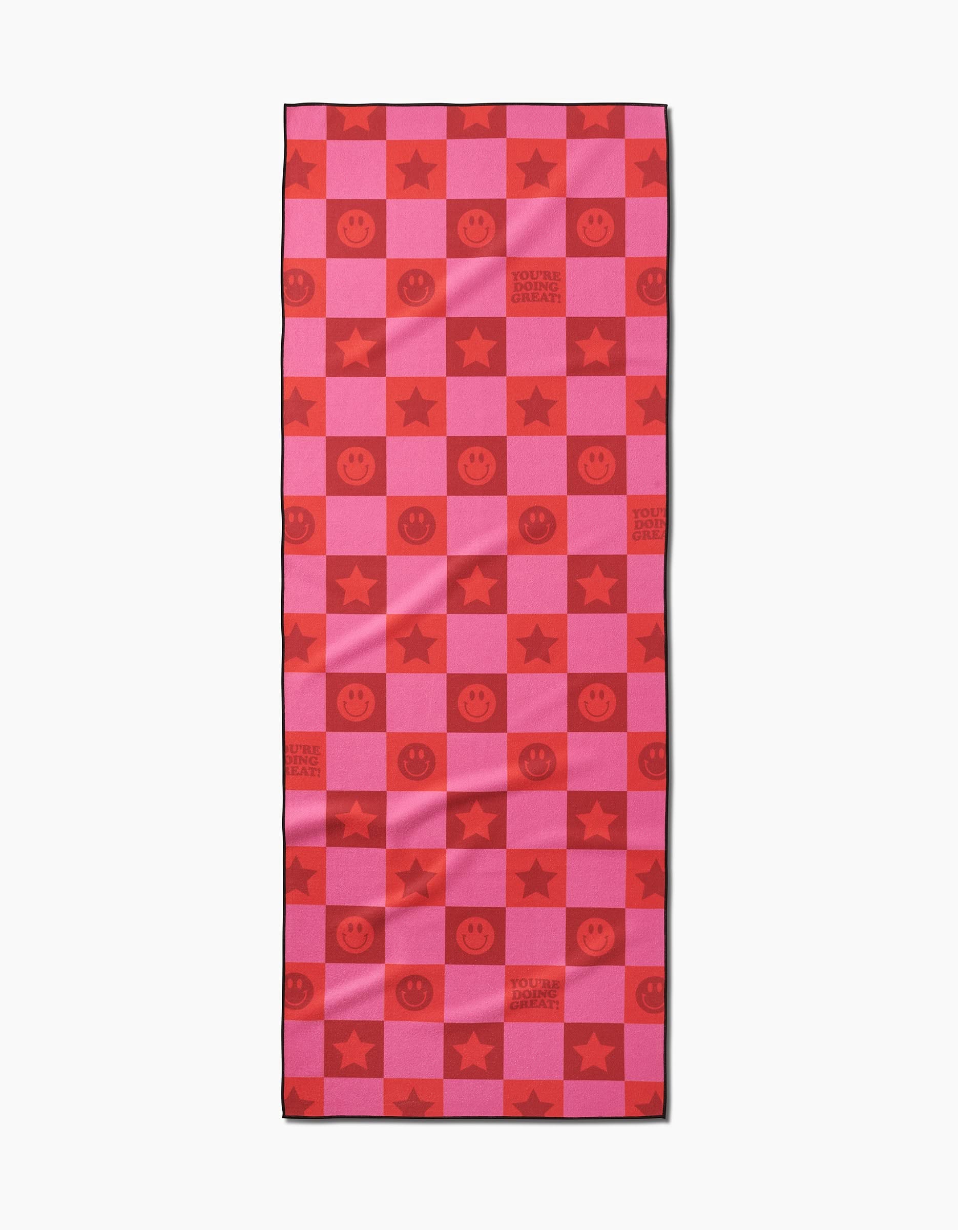 The Youre Doing Great yoga towel by Quotes by Christie features a red and pink checkerboard with smiley faces, stars, and YOU ARE LOVED ALWAYS text in the squares. Its crafted from recycled materials.