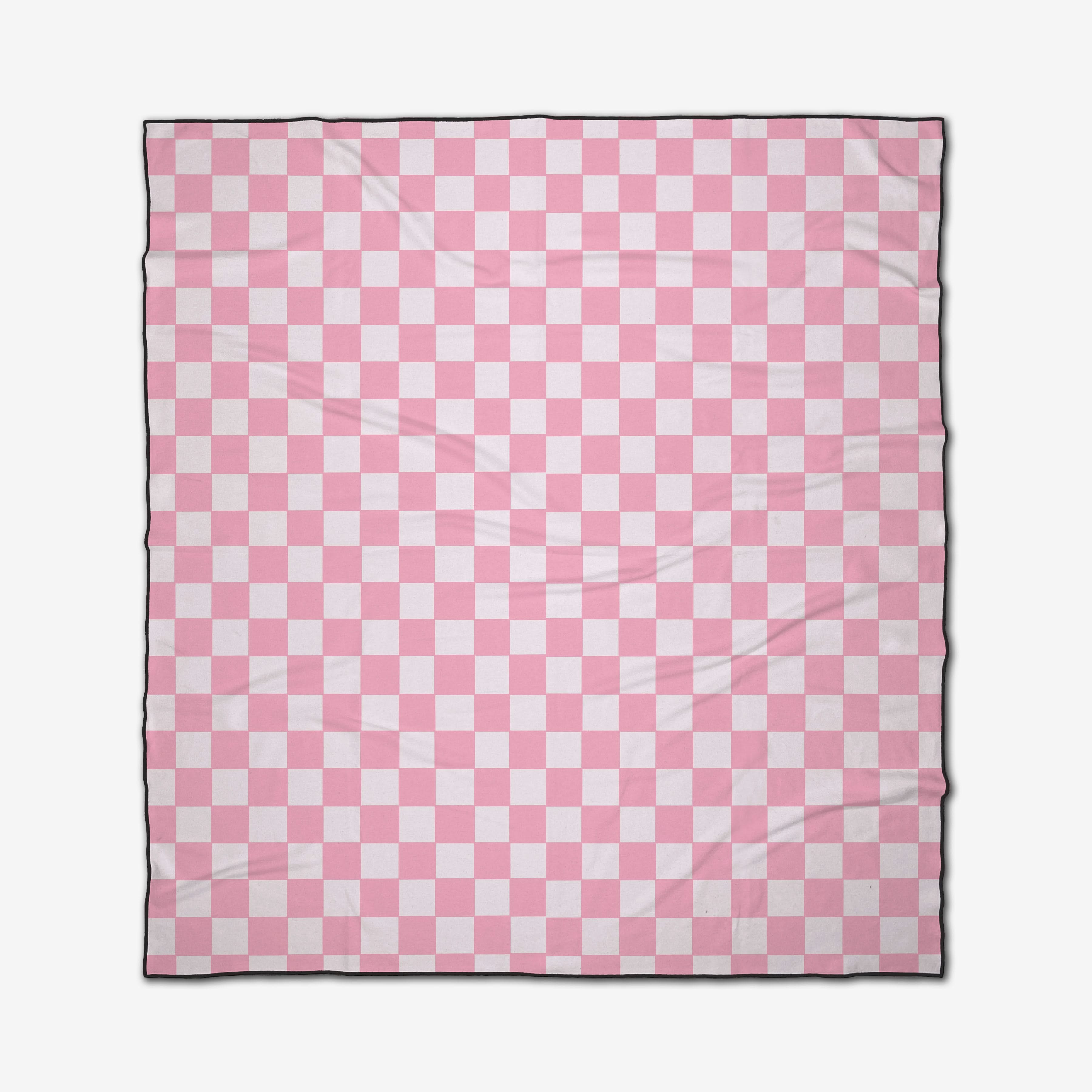 The GEOMETRY Pink Checkers beach blanket features a pink and white checkerboard pattern with evenly spaced squares and subtle fabric wrinkles. Quick-drying for convenience.