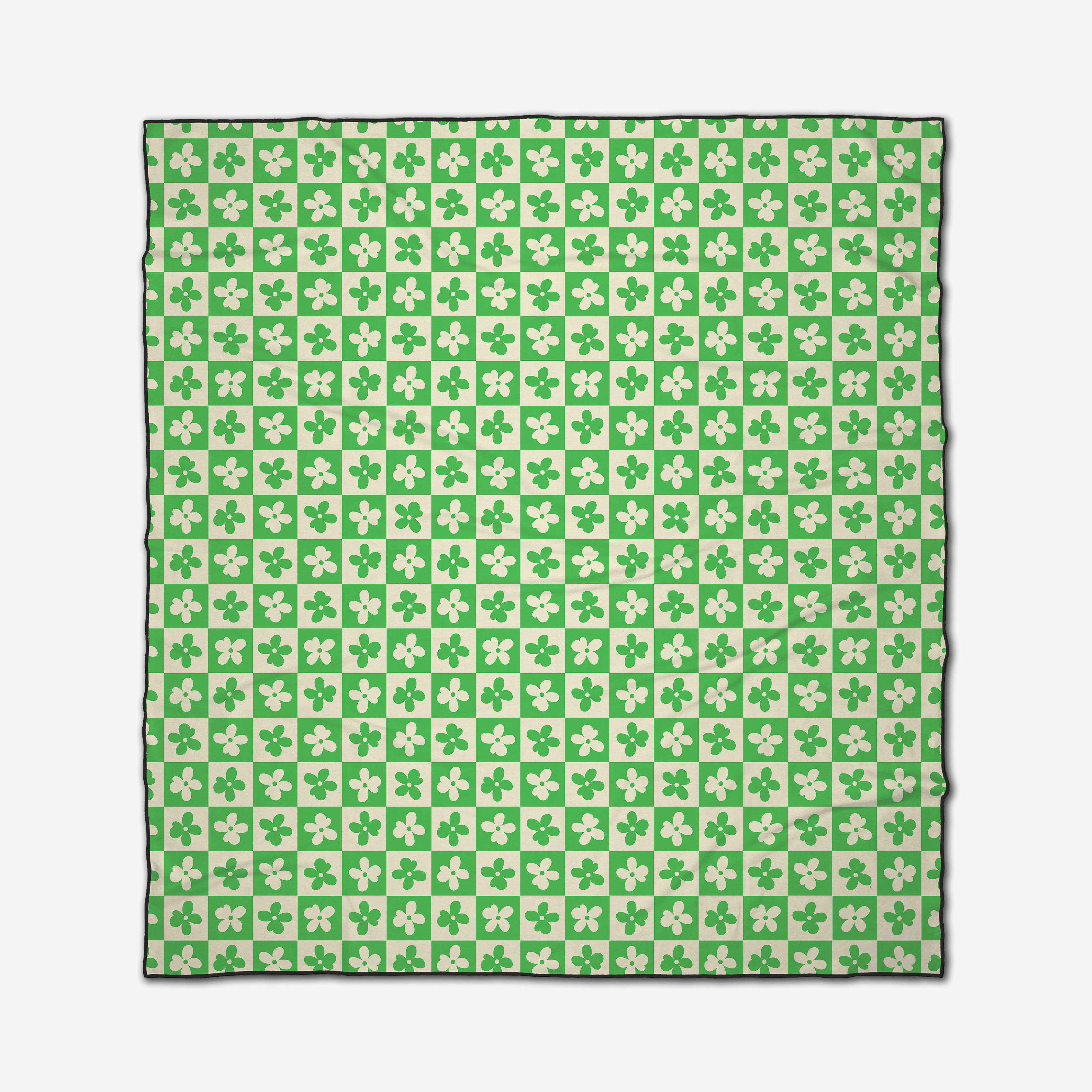 The GEOMETRY Spearmint Green Flowers Beach Blanket features a square checkerboard pattern in green and white with four-leaf clovers, a sleek black border, quick-drying recycled materials.