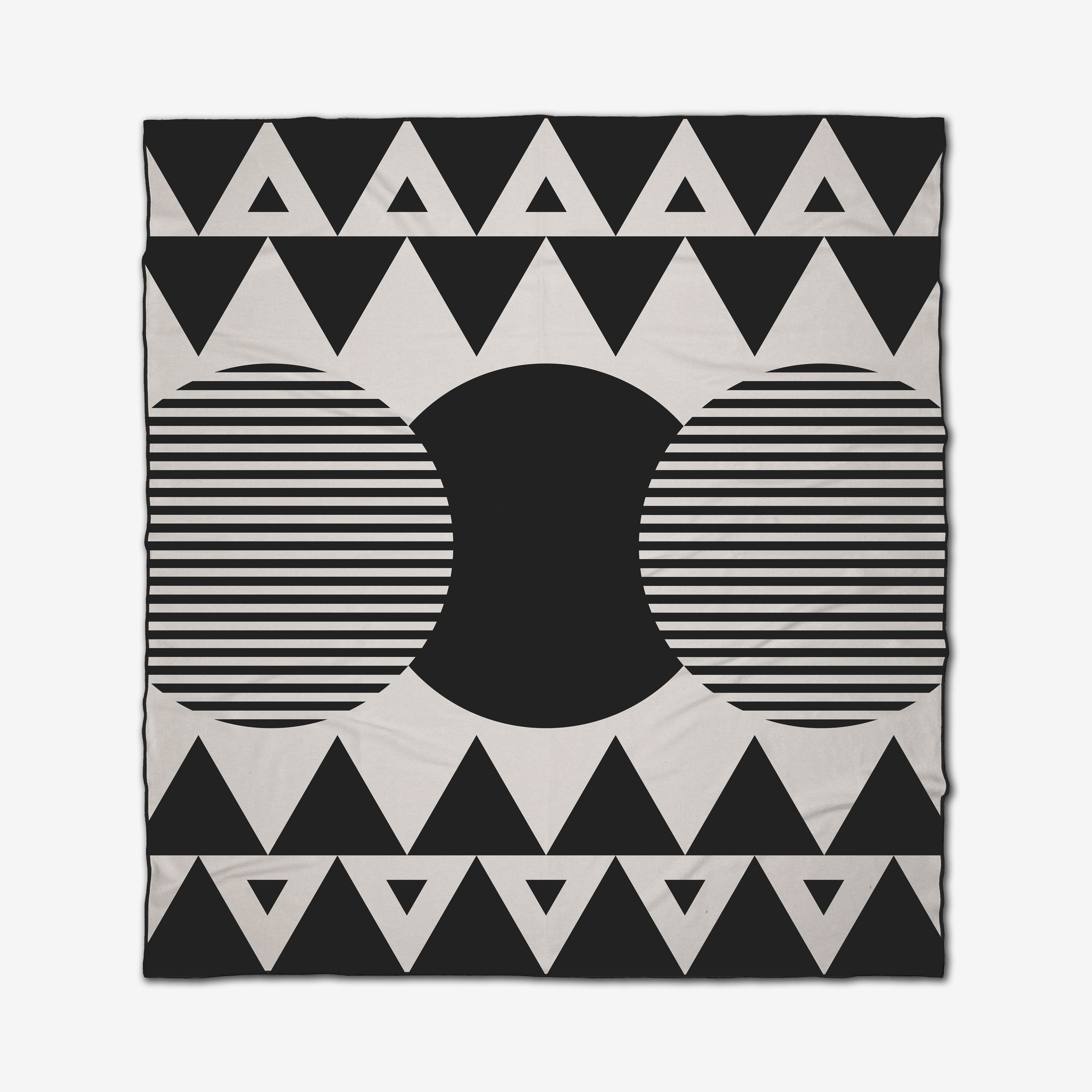 The Outdoors beach blanket by GEOMETRY features a black and white geometric pattern with large circles, a solid black semi-circle center, and a border of black triangles. This quick-drying blanket is perfect for stylish days at the beach.