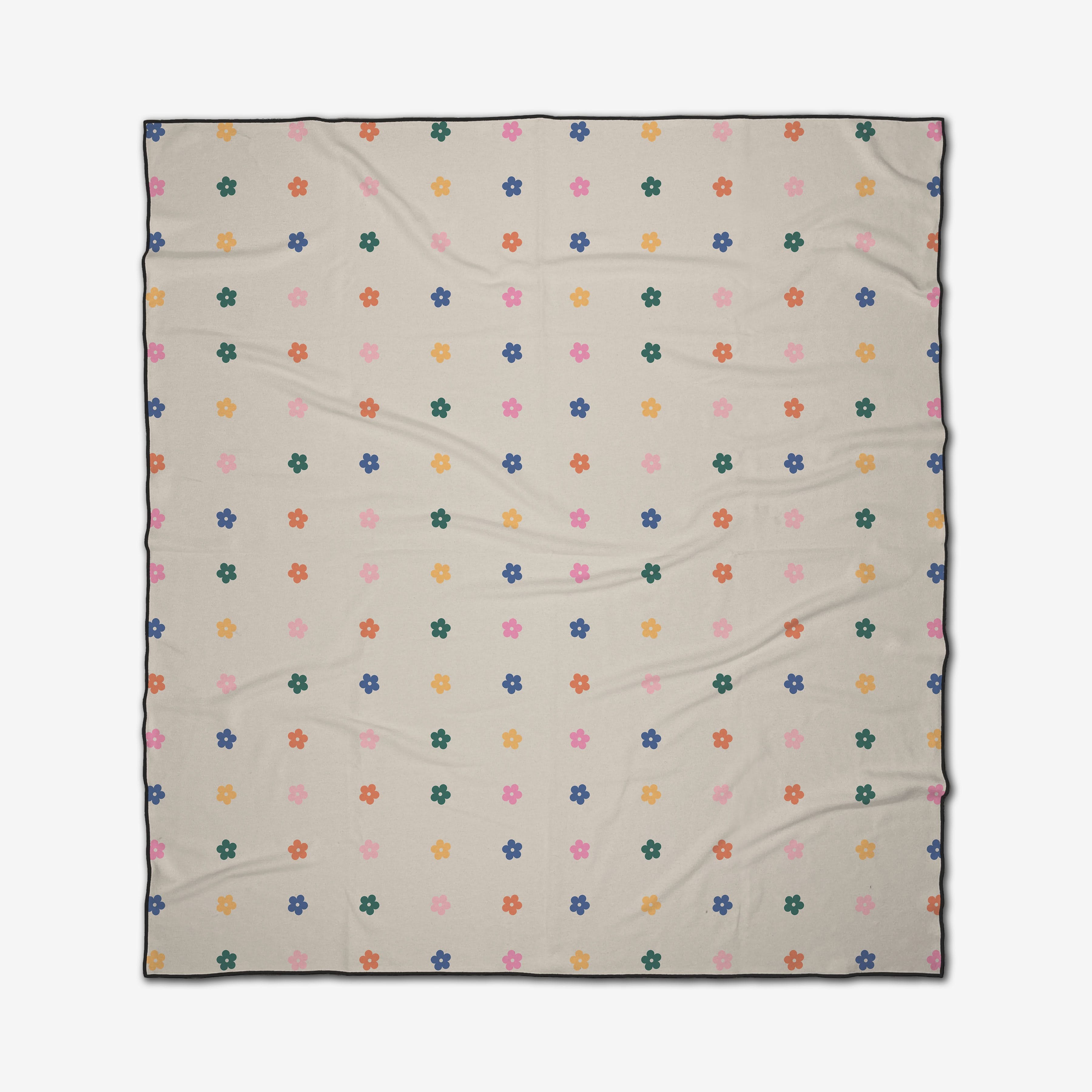 The Treat People with Kindness beach blanket by GEOMETRY features a cream color with a repeating pattern of small multicolored flowers—orange, green, blue, pink, and yellow—and is crafted from quick-drying recycled materials.