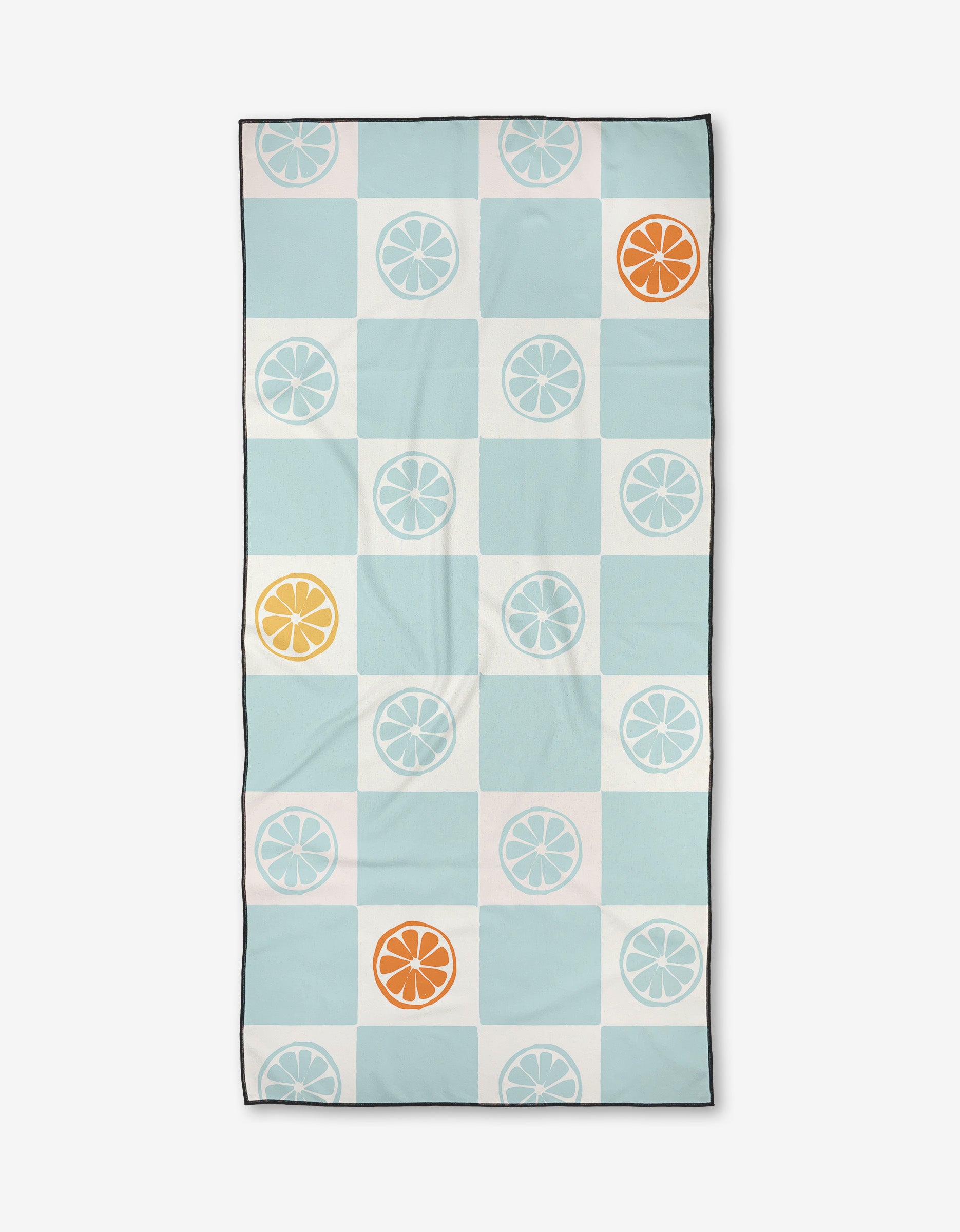 The Citrus Blue beach towel by Janna Sue Design features a grid of blue, white, and teal squares with citrus slice motifs in white, orange, and yellow. Made from recycled materials, it has a thin black border.