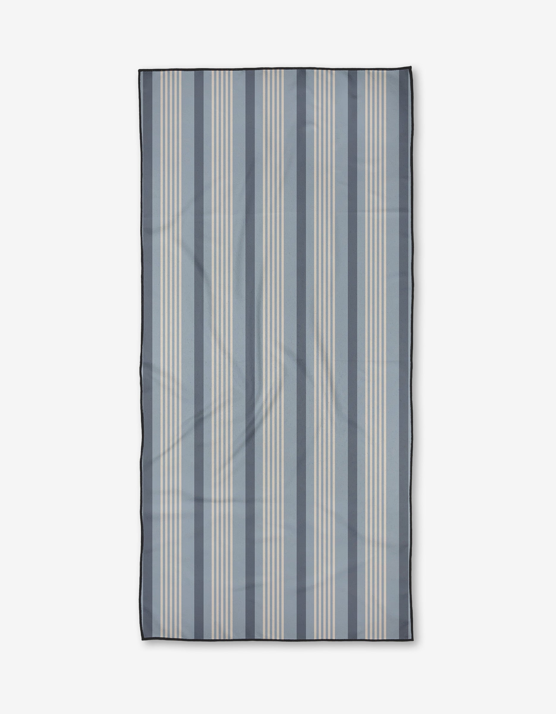 The Colleen beach towel by Becki Owens features vertical blue and light beige stripes on white, finished with a dark border. Made from quick-drying recycled materials for both convenience and sustainability.