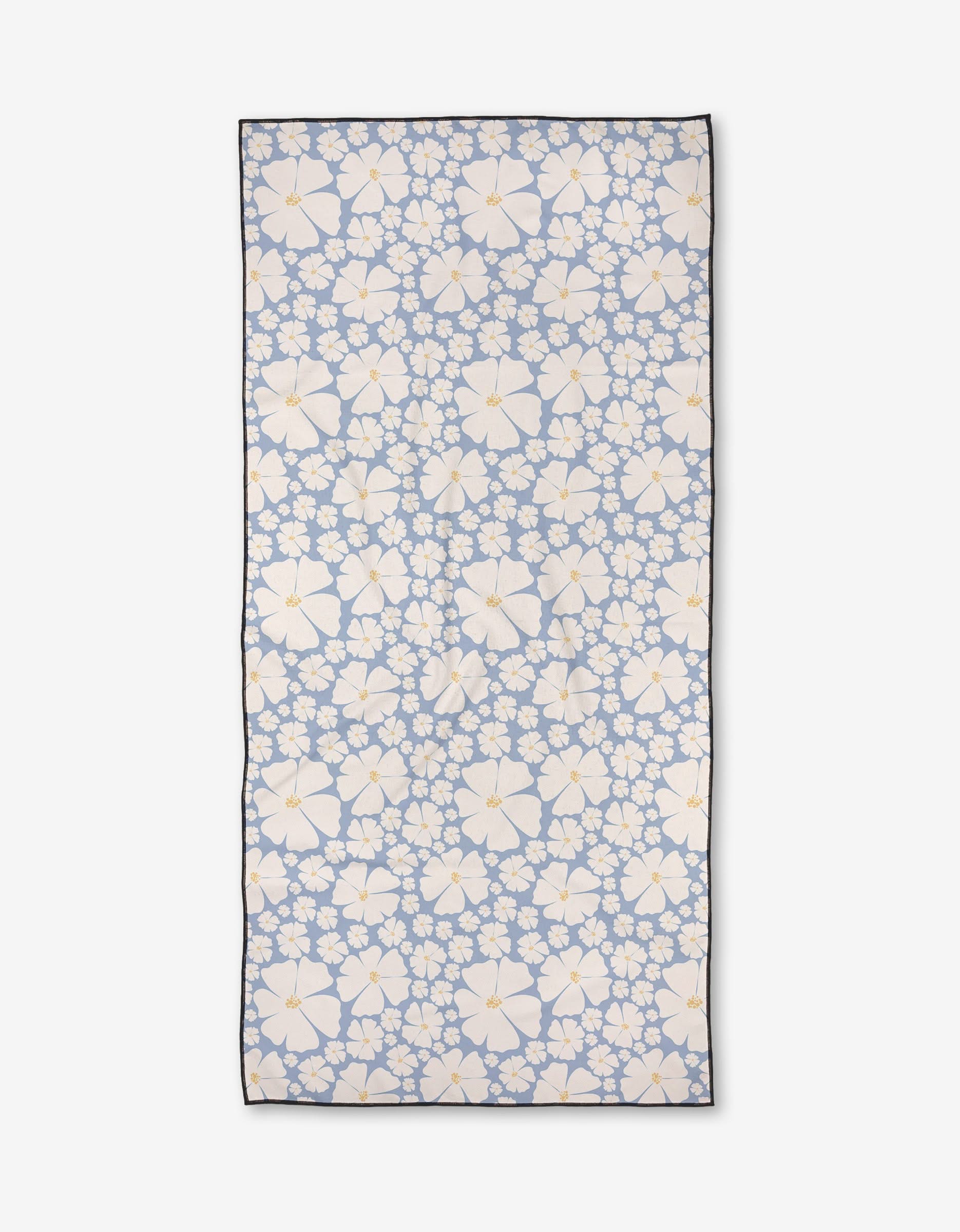 The Daisy Girl Blue by Charlie Rowan Designs is a quick-drying rectangular beach towel featuring a light blue background with large and small white daisies with yellow centers, finished with a thin dark border.