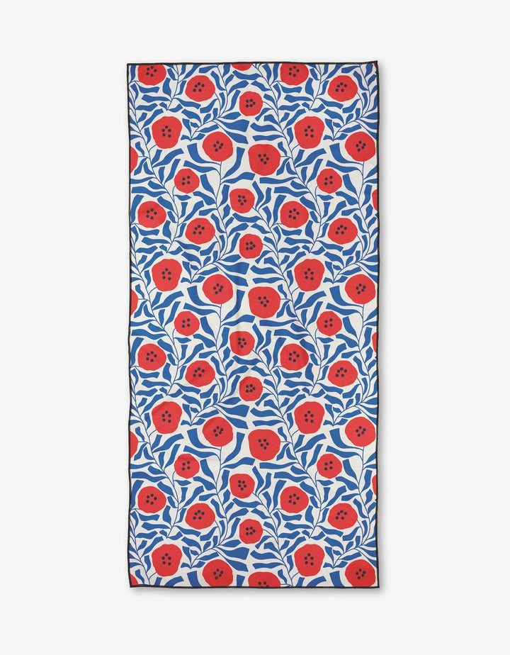 The Happy Hemera Dancing Poppies Micro-loop Beach Towel features a quick-drying, full-coverage floral design of red poppies with dark centers and blue leaves on a white background.