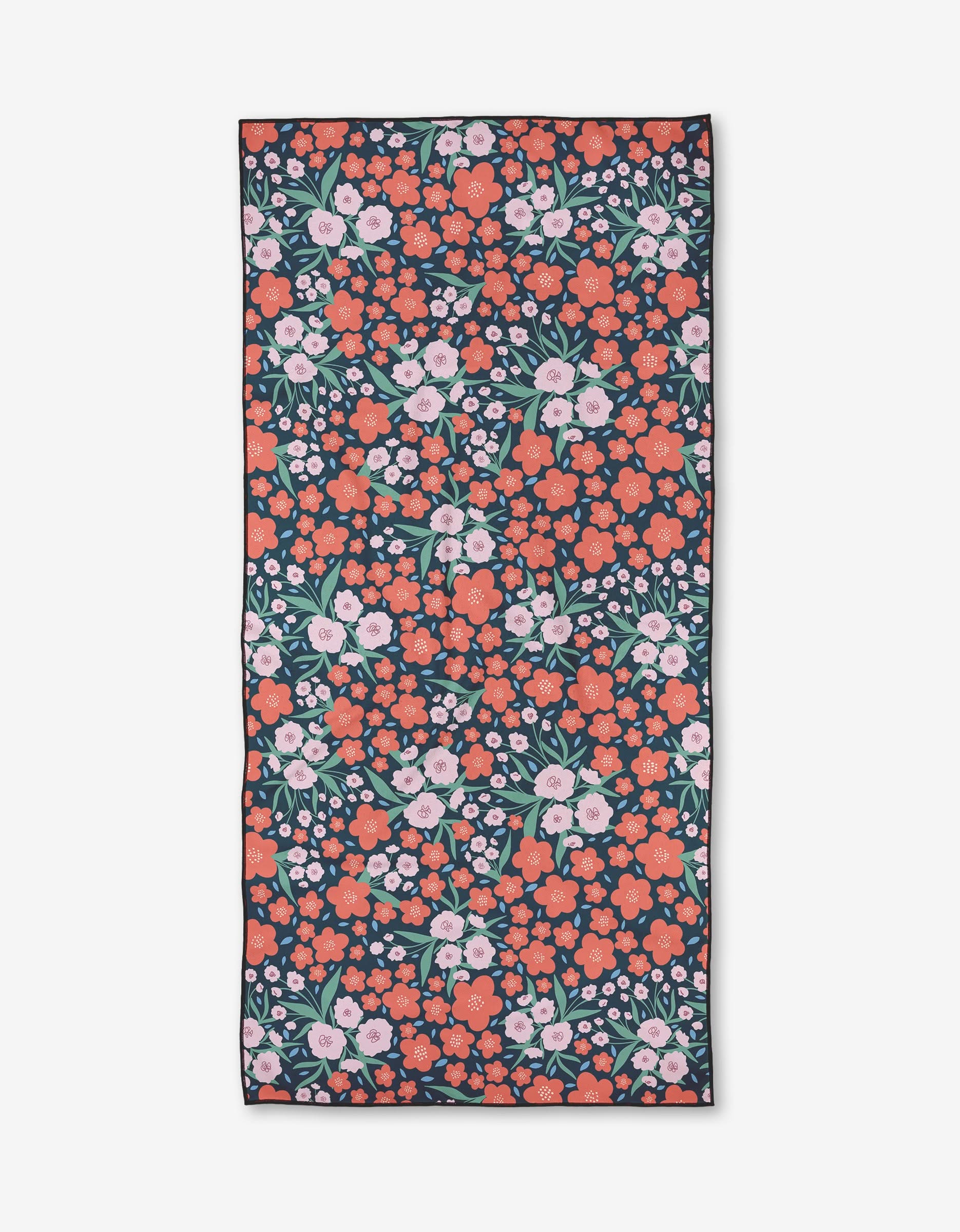 Charlie Rowan Designs Daydreamer is a rectangular Geometry Micro-loop Beach Towel with a dense floral pink and red pattern, green leaves, and white accents on dark fabric, made from quick-drying recycled materials.