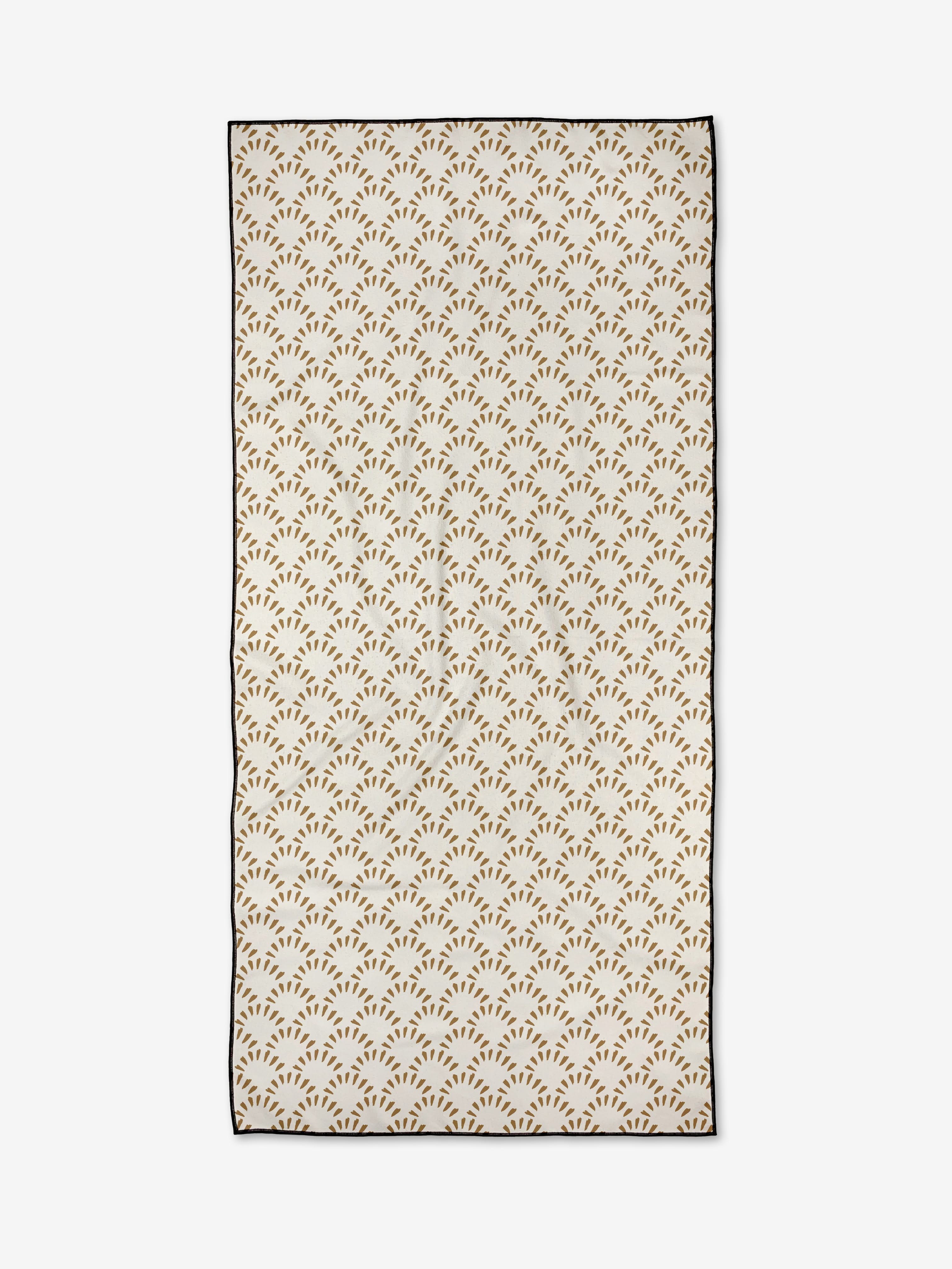 The Fantail by Hufton Studio is a rectangular micro-loop beach towel with small brown, branch-like geometric patterns on white, quick-drying fabric and a thin black border.