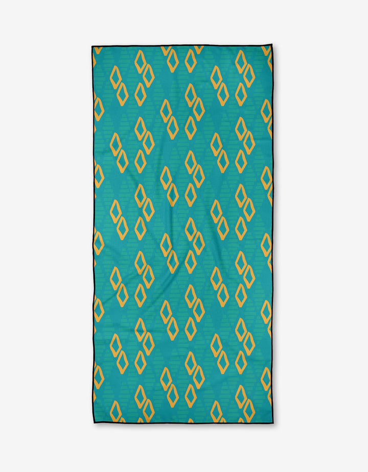 The Sareka Unique Girls Best Friend is a rectangular teal micro-loop beach towel made from recycled materials, featuring evenly spaced yellow diamond shapes outlined in black.