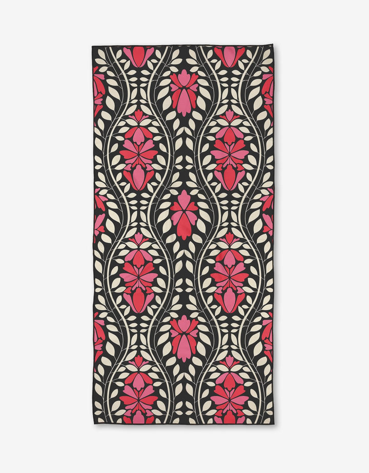 The Glowing Garden Path by Rebecca Woolbright is a rectangular rug with pink flowers and cream leaves in an ornate, symmetrical design on black—crafted from recycled materials for eco-friendly style.