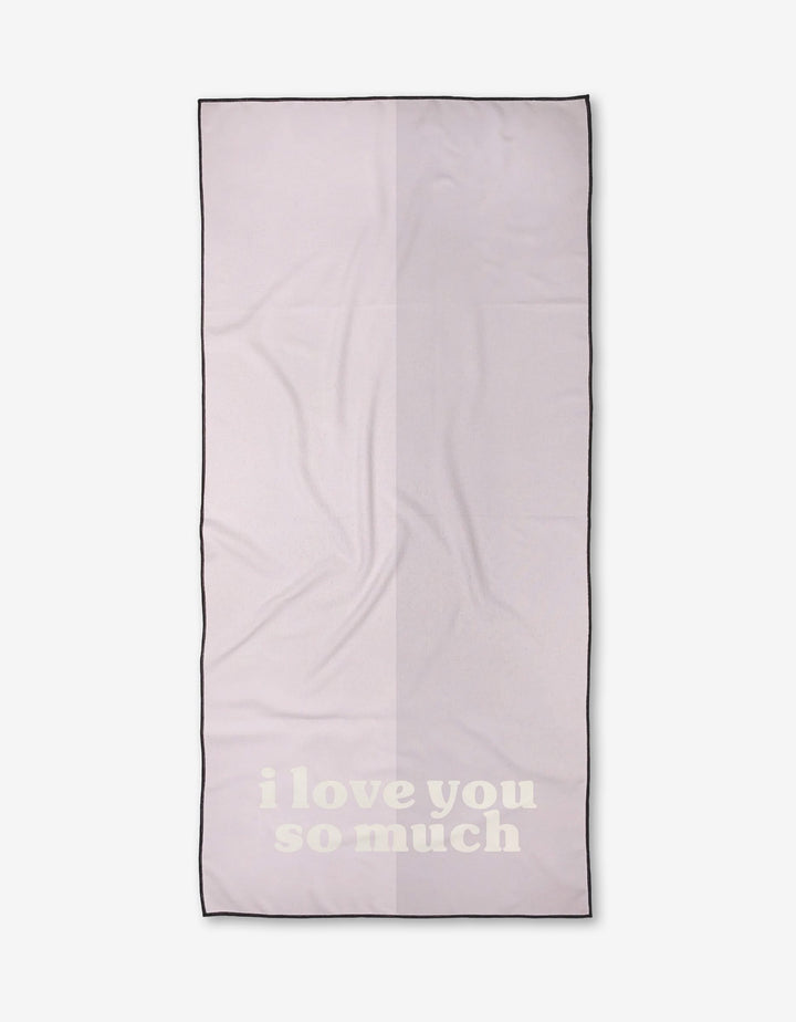 A light pink rectangular Kelsi Fullmer ilysm Micro-loop Beach Towel with black trim and i love you so much in large white letters near the bottom.