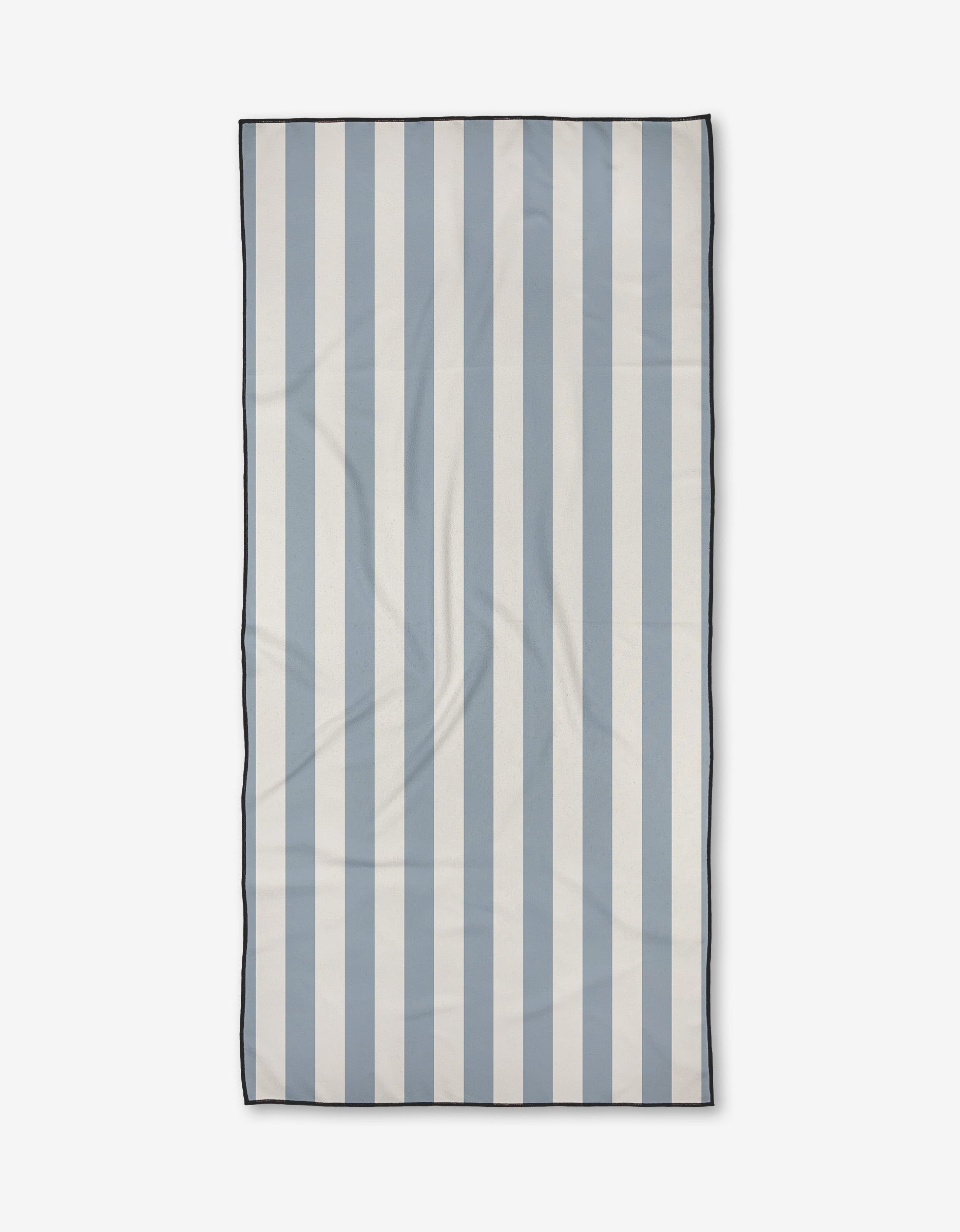 The Becki Owens Julia towel, a rectangular ultra-absorbent piece with vertical light blue and white stripes and a thin dark border, is shown laid flat on a plain white background.
