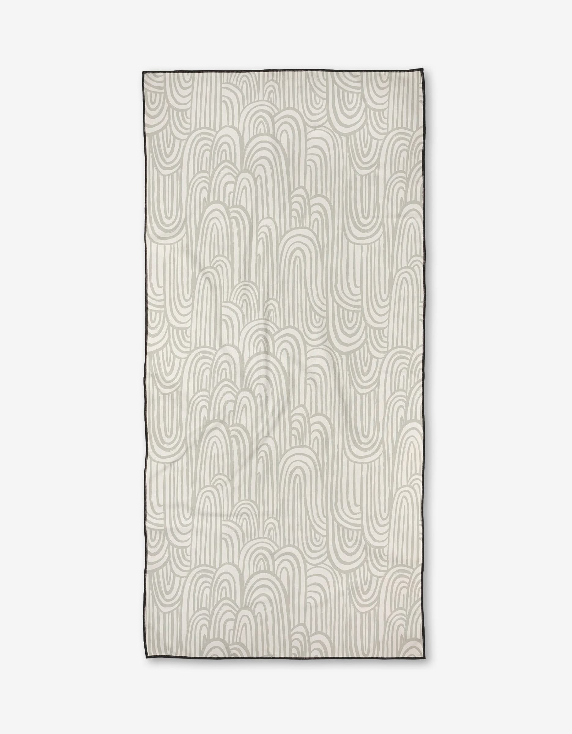The Lovers Arc rug by Hufton Studio features a cream base with overlapping, curved light gray lines forming abstract arches and loops. Made from recycled materials, it has a thin dark border for a modern touch.