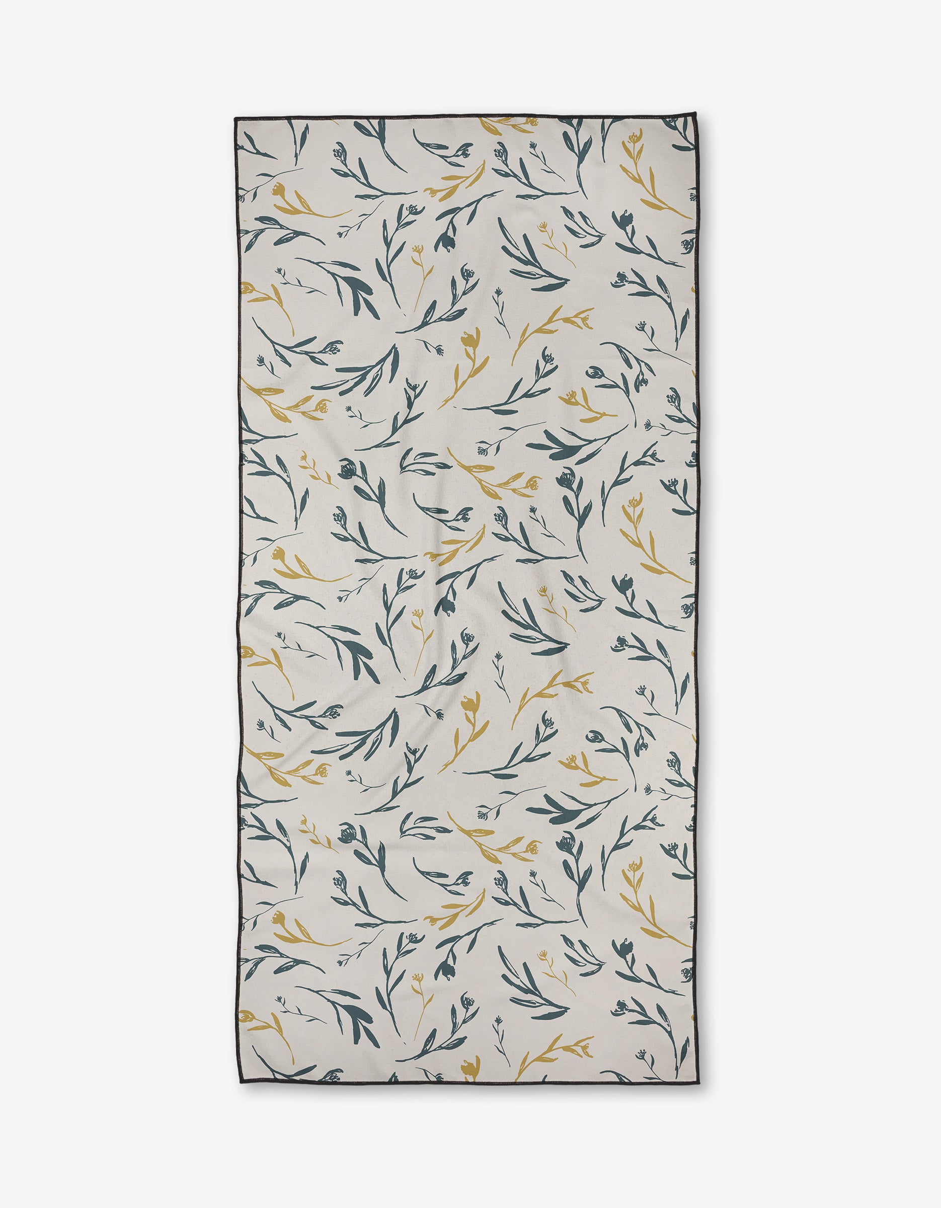 The Meander beach towel by Toboggan Avenue features green and yellow leafy branches on a white background, black-outlined edges, and natural folds. Made from recycled materials, this towel is quick-drying and rectangular in shape.