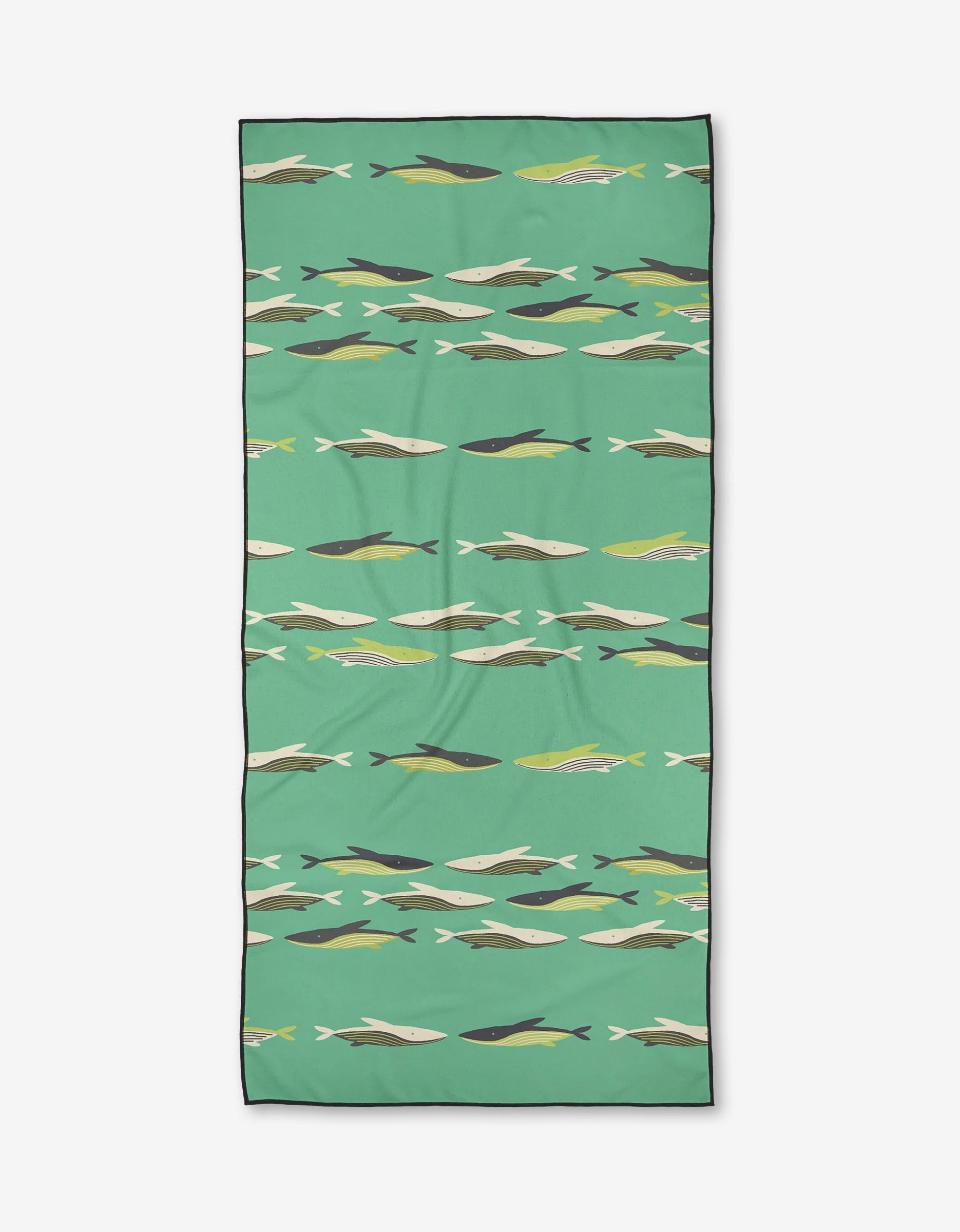 The Jessica Swift Oceania beach towel is rectangular and green, with rows of stylized fish in white, yellow, black, and gray. Made from quick-drying recycled materials.