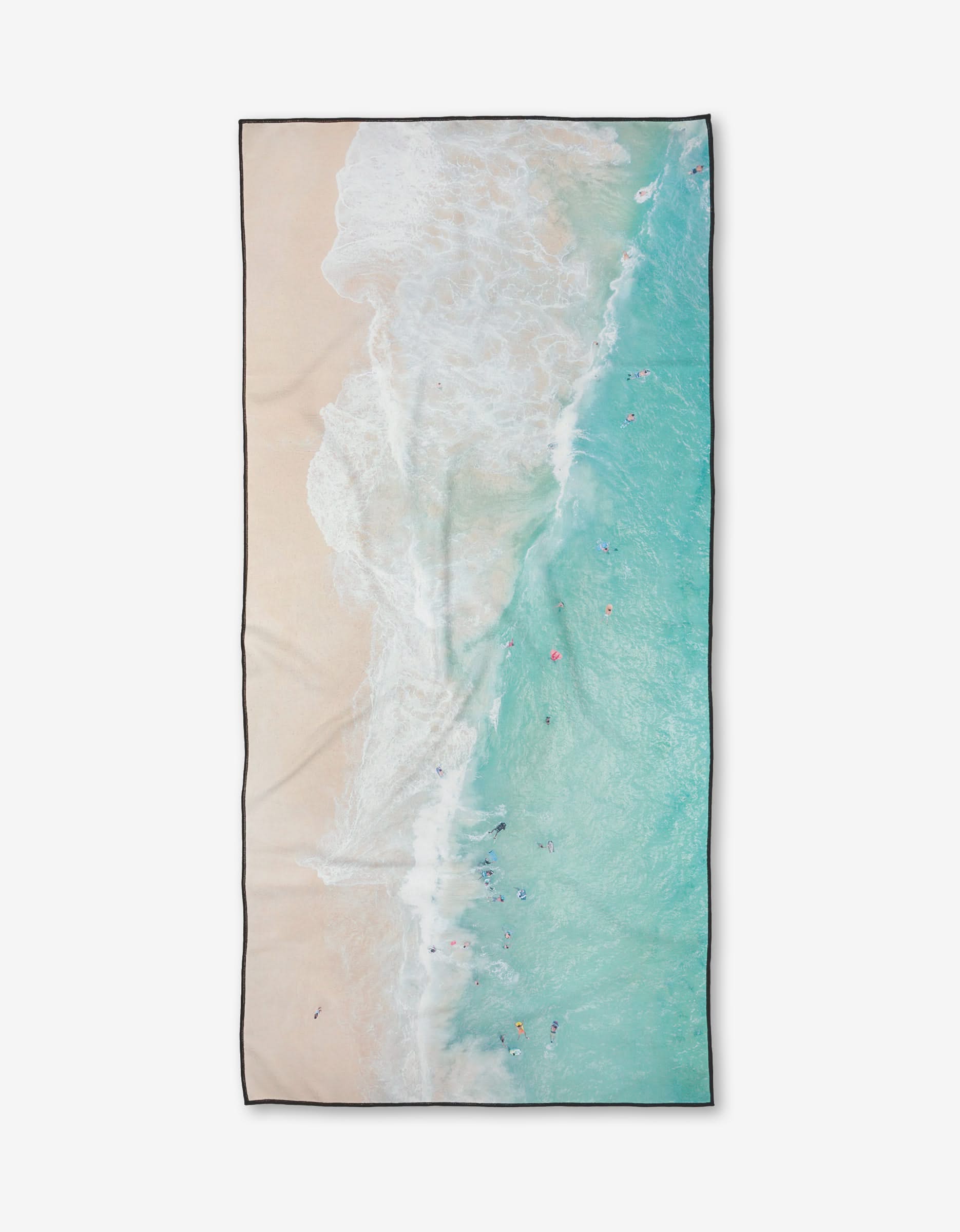 The Out to Sea beach towel by Kait Hanson features an aerial view of turquoise waves and sandy shore with swimmer-like dots. Made from quick-drying, recycled materials, its an eco-friendly, comfortable choice for your beach days.