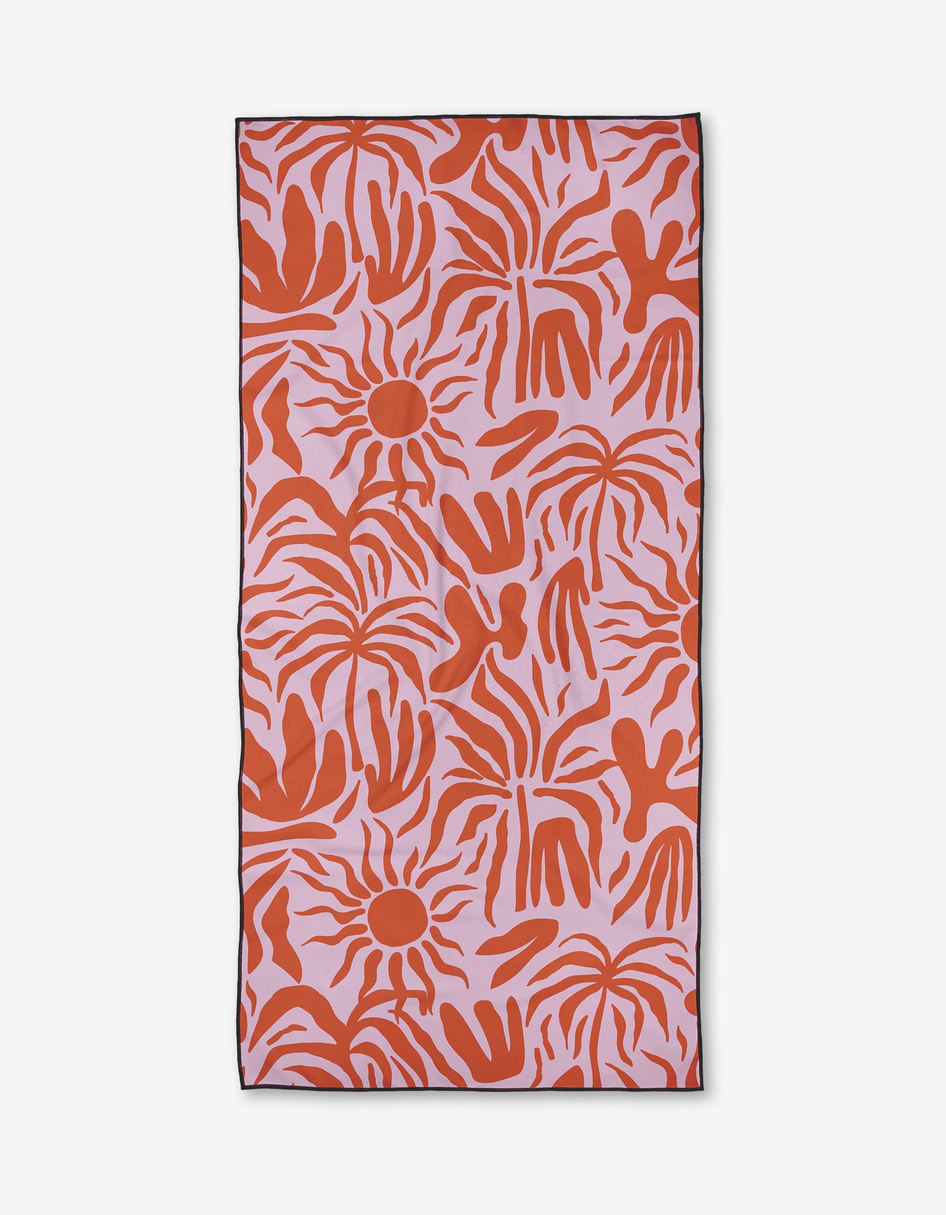 The Summer Sunset beach towel by Marina Solodka features a pink background with bold, abstract red sun shapes and handprints. Made from quick-drying recycled materials, it has a black border and is shown on a white surface.