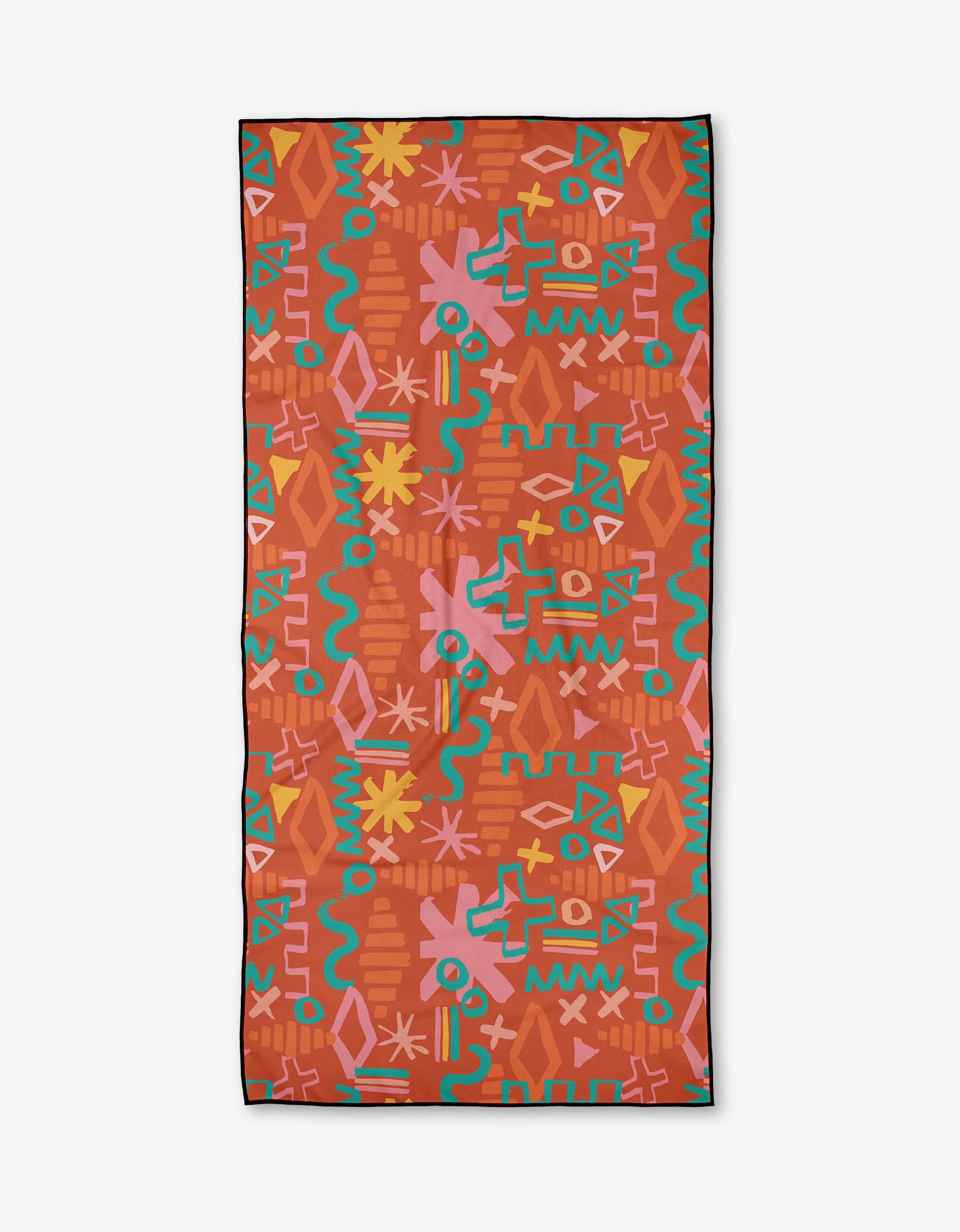The Superstar Micro-loop Beach Towel by Sareka Unique features a vibrant, abstract geometric pattern—zigzags, crosses, and stylized flowers—in red, teal, orange, yellow, and pink on a reddish-orange background. Made from recycled materials.