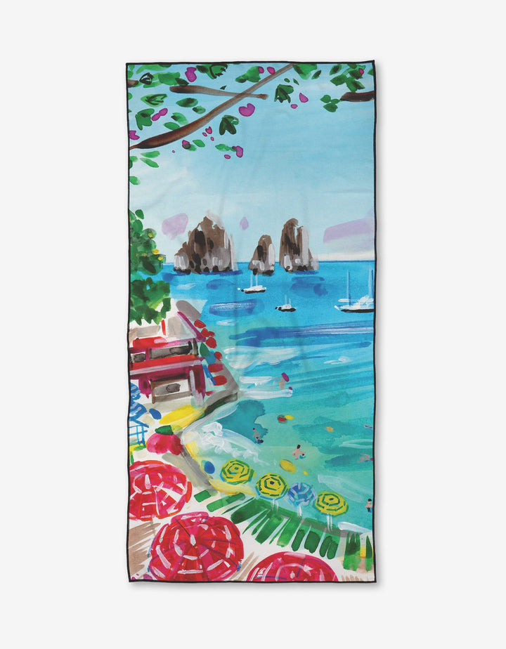 Enjoy the vibrant Take Me to Capri Micro-loop Beach Towel by Travel Write Draw by Meagan Morrison, featuring a Mediterranean seaside scene—turquoise waters, sailboats, and bright flowers—made from quick-drying recycled materials.
