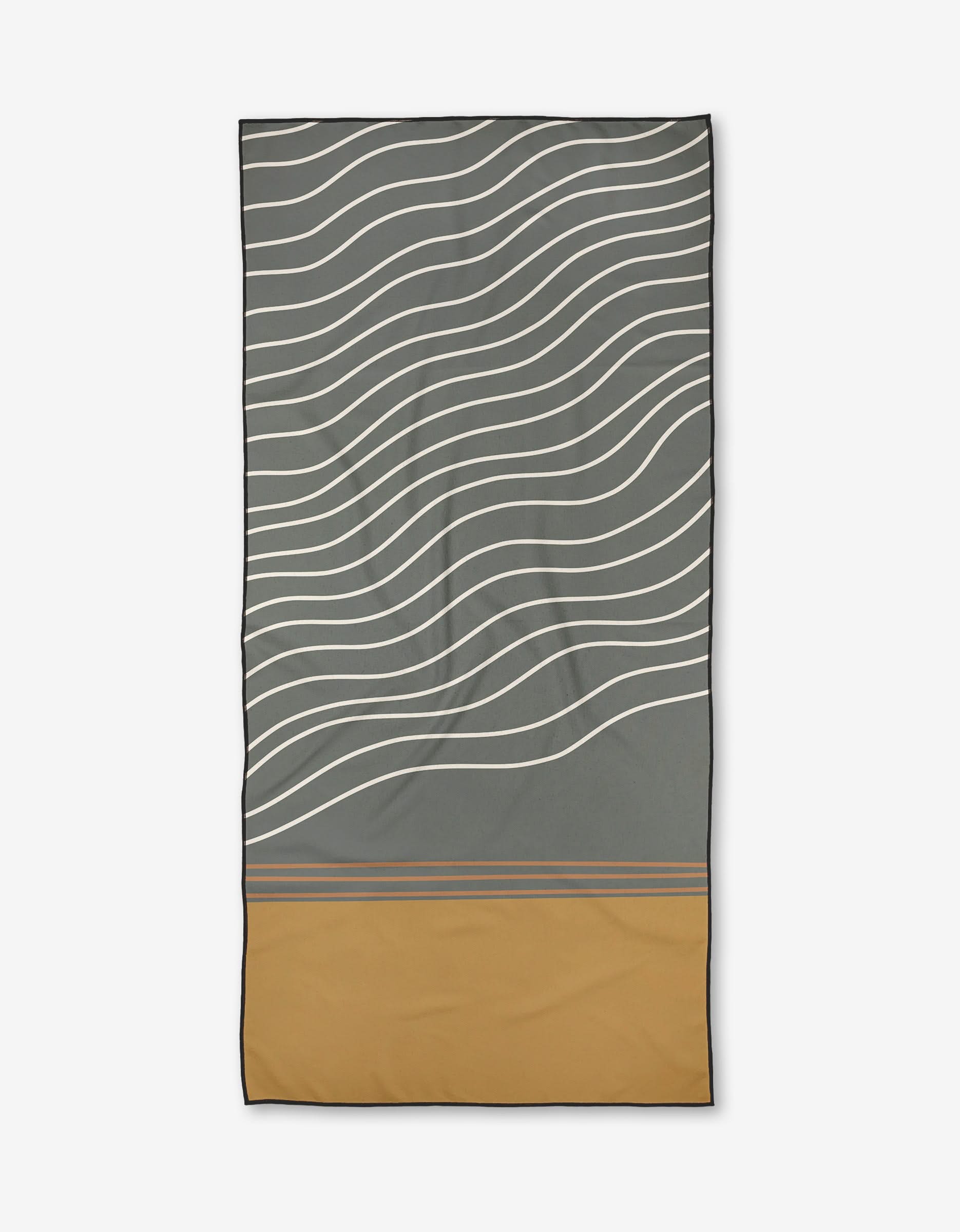 The Wavey Beach towel by Coit Creative features wavy white lines on gray with a solid mustard yellow bottom, separated by thin gray stripes. Made from recycled materials and quick-drying micro-loop fabric.