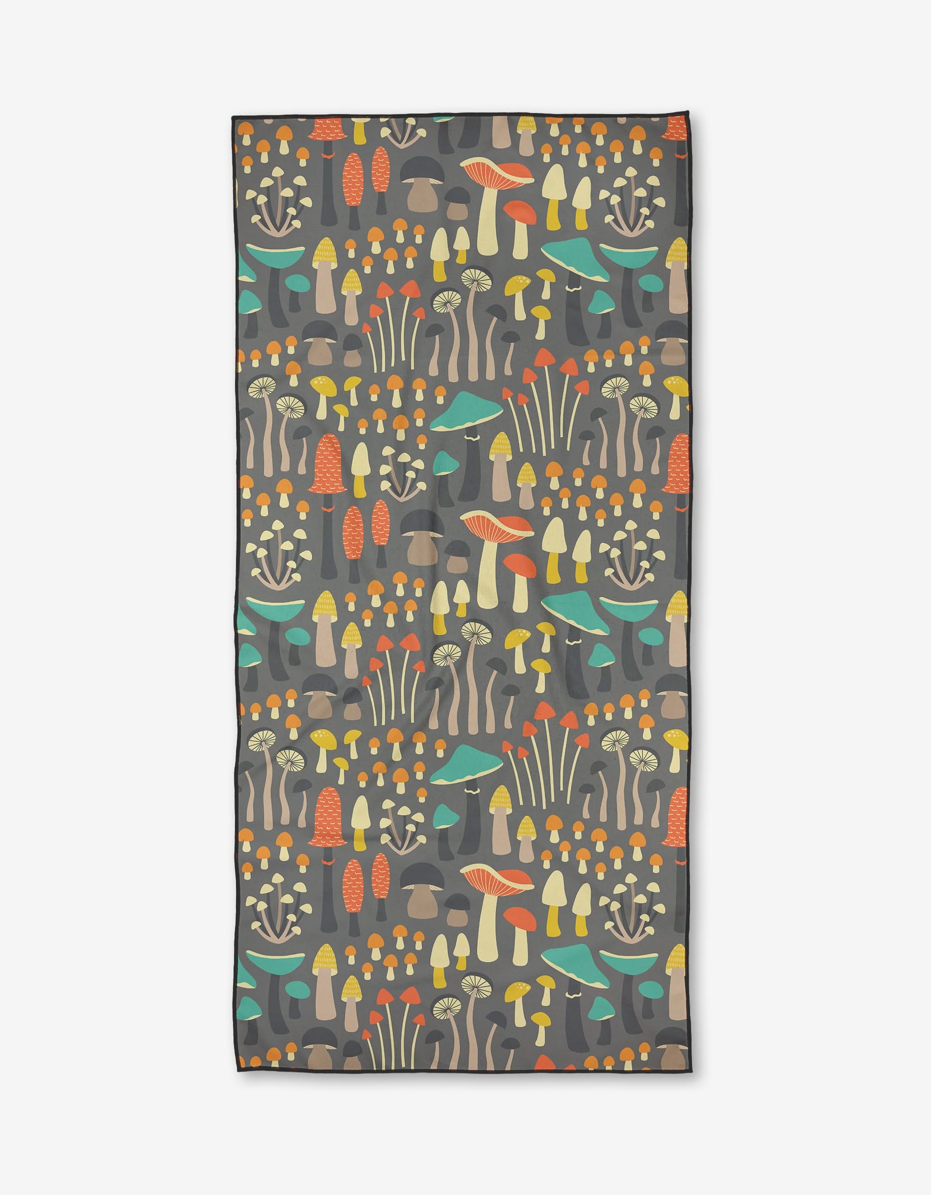 The Megan Kampa Wild Forage Micro-loop Beach Towel features a rectangular shape and a vibrant repeating mushroom pattern in orange, yellow, green, and beige on dark gray. Made from quick-drying recycled materials, its shown flat on a white surface.