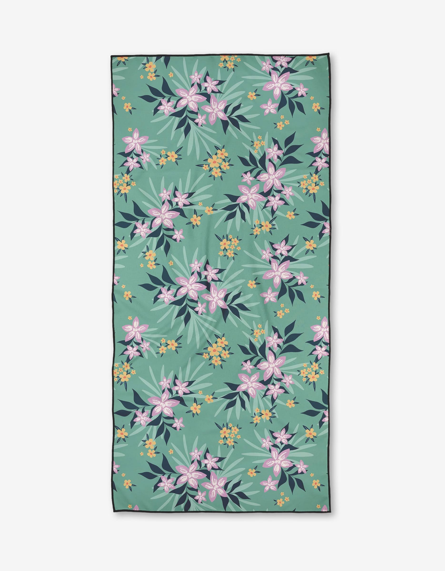 The Wilder towel by Charlie Rowan Designs is a rectangular, quick-drying towel with a green background and a pattern of pink, yellow, and white tropical flowers plus green and dark blue leaves.