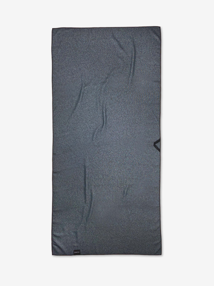 A dark gray, rectangular Happy Hemera Happy Check Micro-loop Beach Towel, made from recycled materials with a subtle textured pattern and slight creases, is displayed flat on a white background.