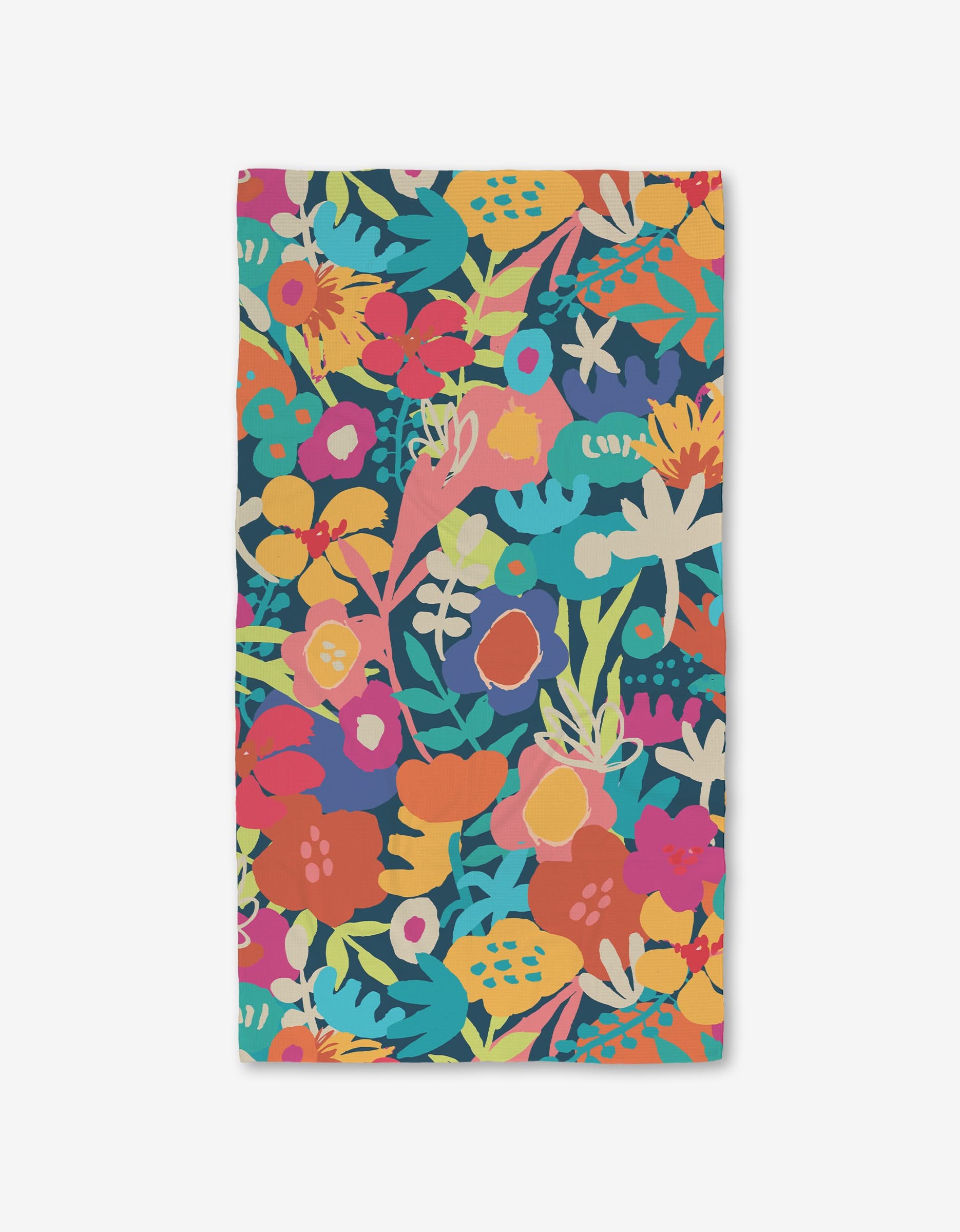 The Sareka Unique Bright Bunch bath towel is rectangular and ultra-absorbent, made from recycled materials with a vibrant floral print in red, orange, yellow, pink, teal, and green on a dark background.