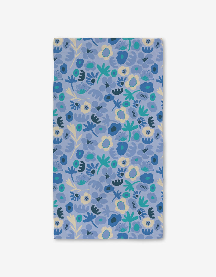 The Sareka Unique Cool Blooms bath towel features a dense pattern of blue, yellow, and green flowers and leaves on light blue, crafted with Geoweave technology for ultra-absorbency across the entire surface.