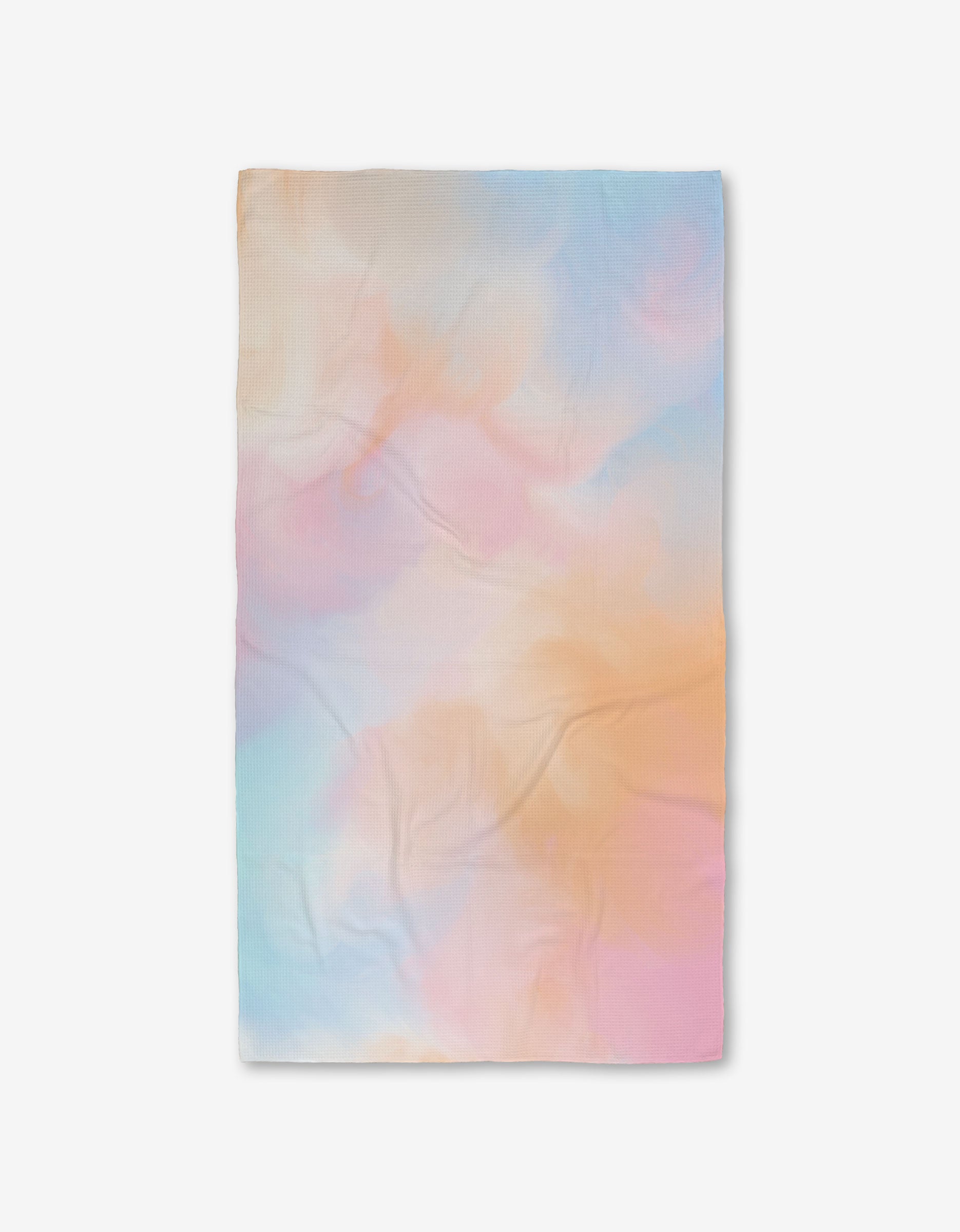 The GEOMETRY Cotton Candy Skies blanket features a soft, pastel tie-dye design in blue, pink, orange, and purple, made from post-consumer recycled materials and shown flat on a white background.