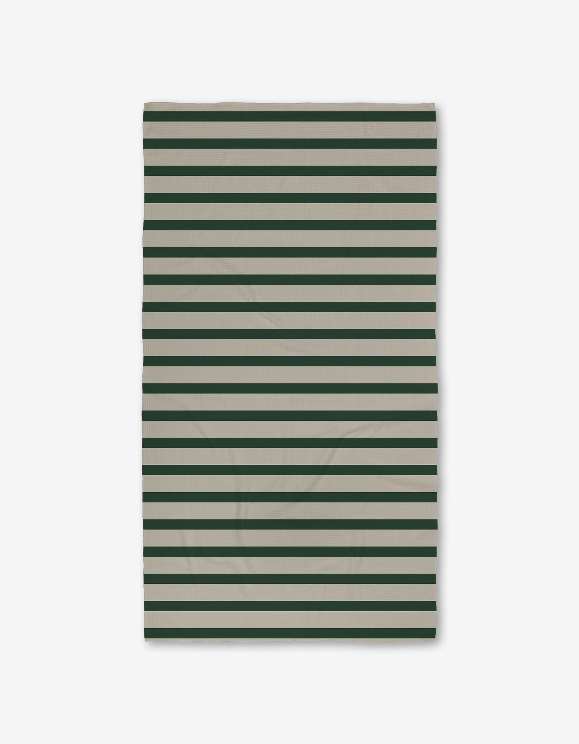 The GEOMETRY Deep Green Stripes Luxe Bath Towel, made from recycled materials and featuring horizontal dark green and beige stripes, is shown flat on a white background.