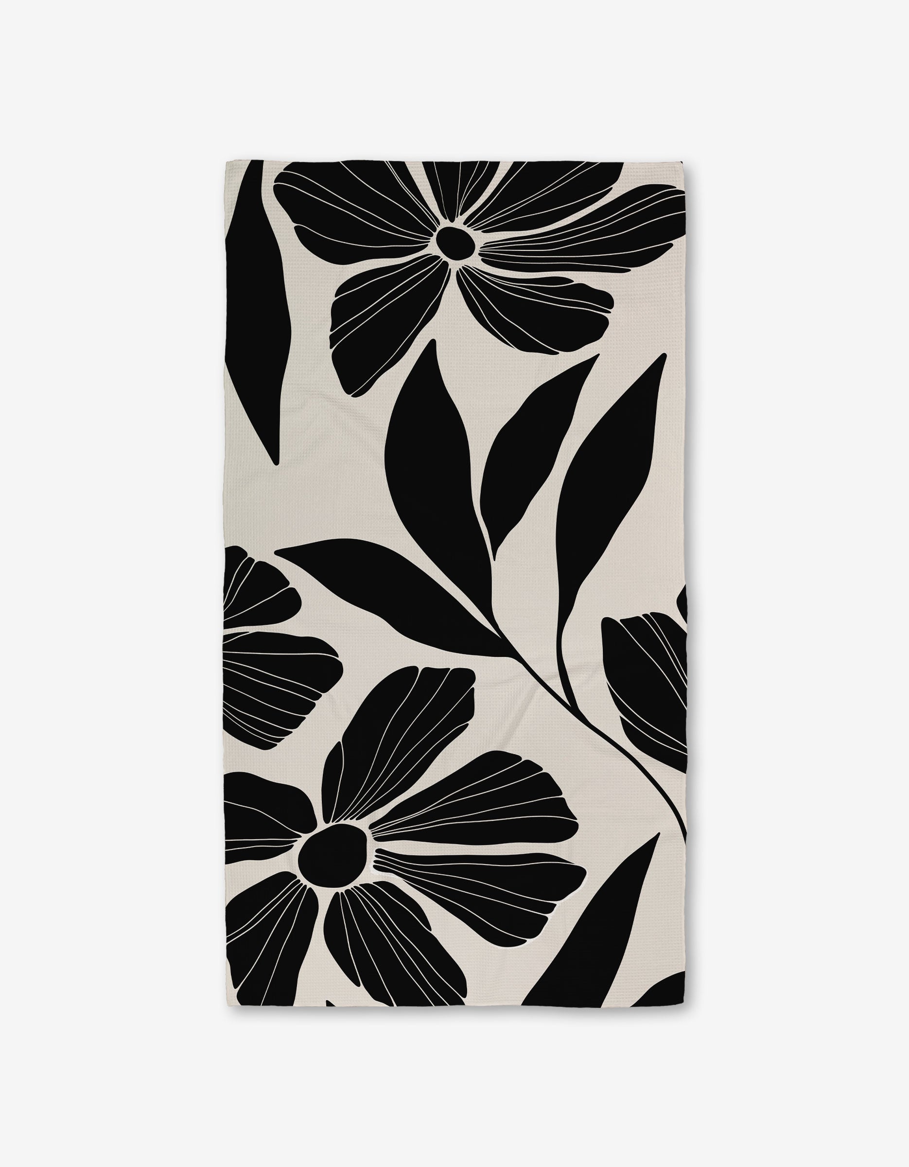 The Harmony Bath Towel by GEOMETRY is a rectangular, ultra-absorbent towel featuring bold black and white abstract florals on a light background, crafted with Geoweave technology for superior comfort.