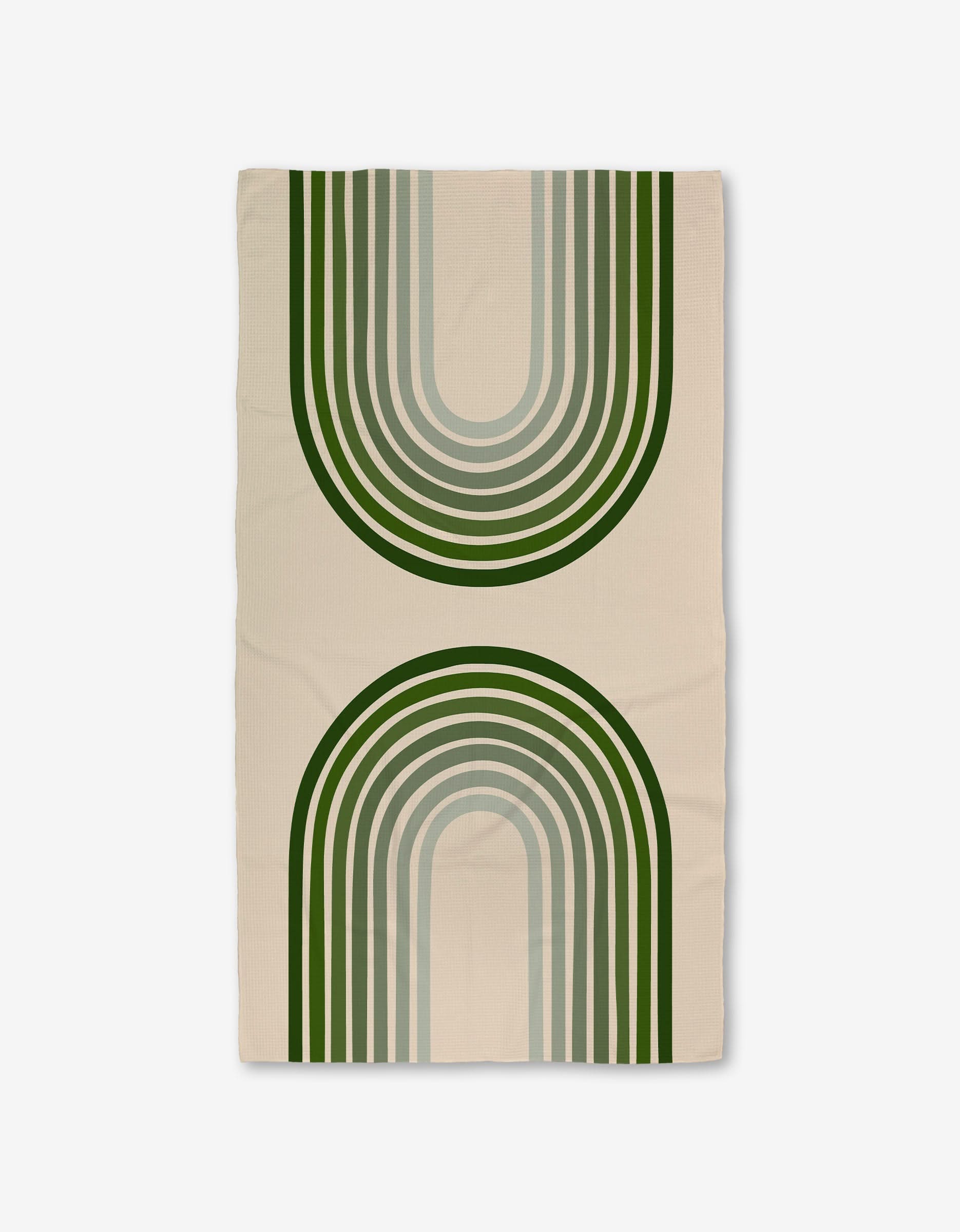 The Olive Arches rug by GEOMETRY is a beige rectangle made with Geoweave technology, showcasing two large green and gray arches—one upward, one downward—for a modern, symmetrical look.