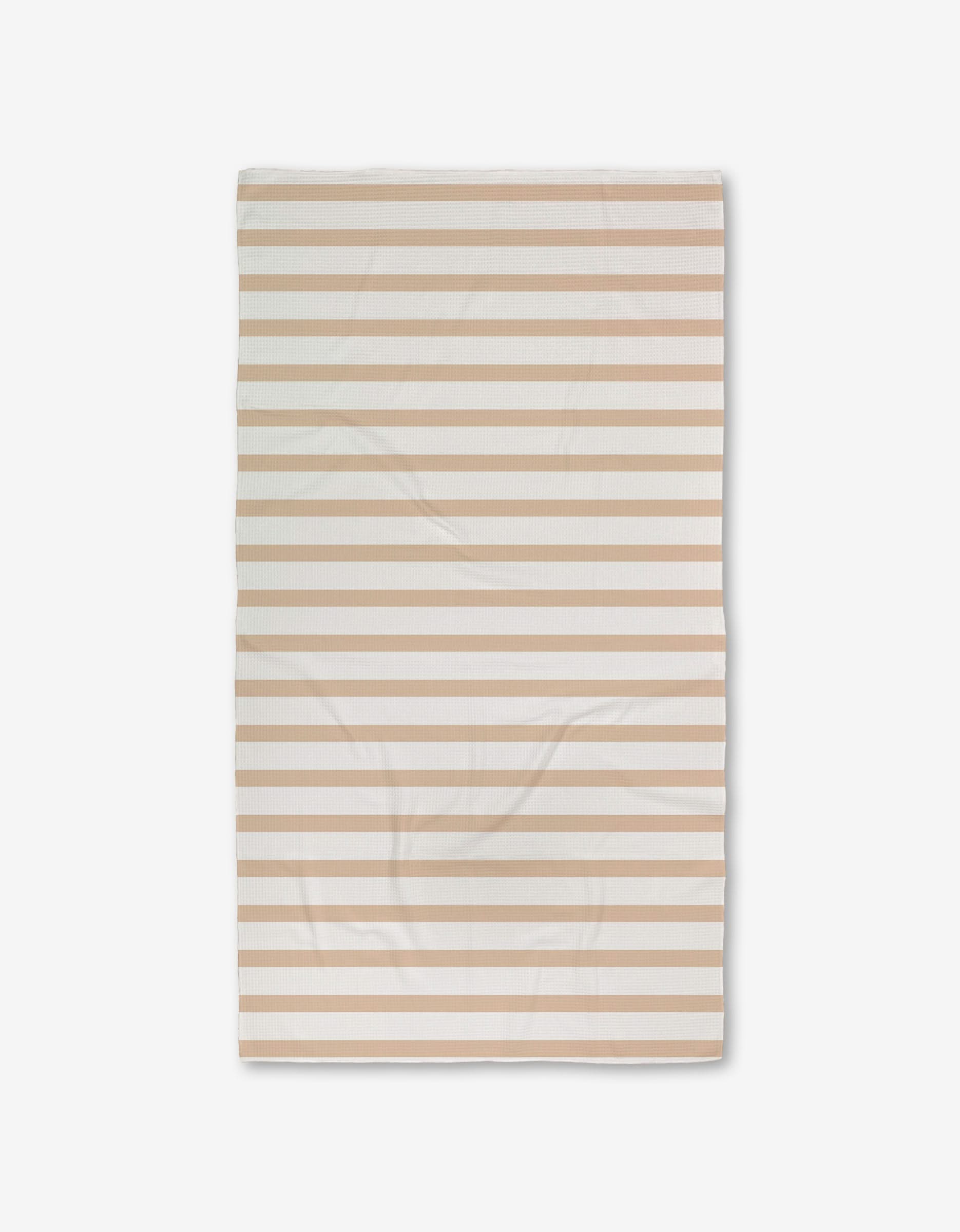 A rectangular GEOMETRY Sandalwood Stripes bath towel with horizontal beige and white stripes, featuring ultra-absorbent Geoweave technology, is laid flat on a white background and appears slightly wrinkled.