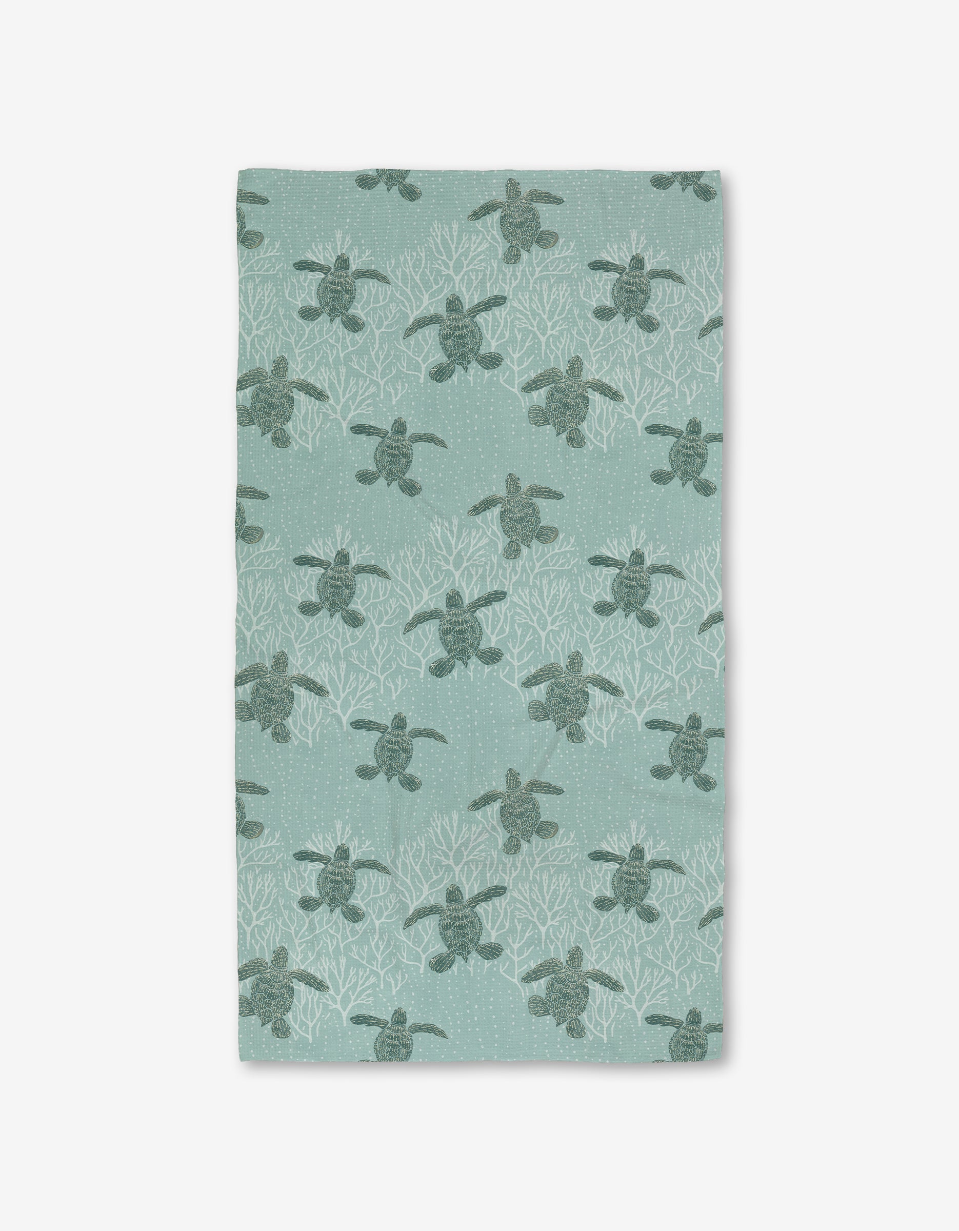 The Katie OShea Sea Turtles Luxe Bath Towel showcases sea turtles among white coral on a light teal background, made with Geoweave technology for an ultra-absorbent, premium feel.