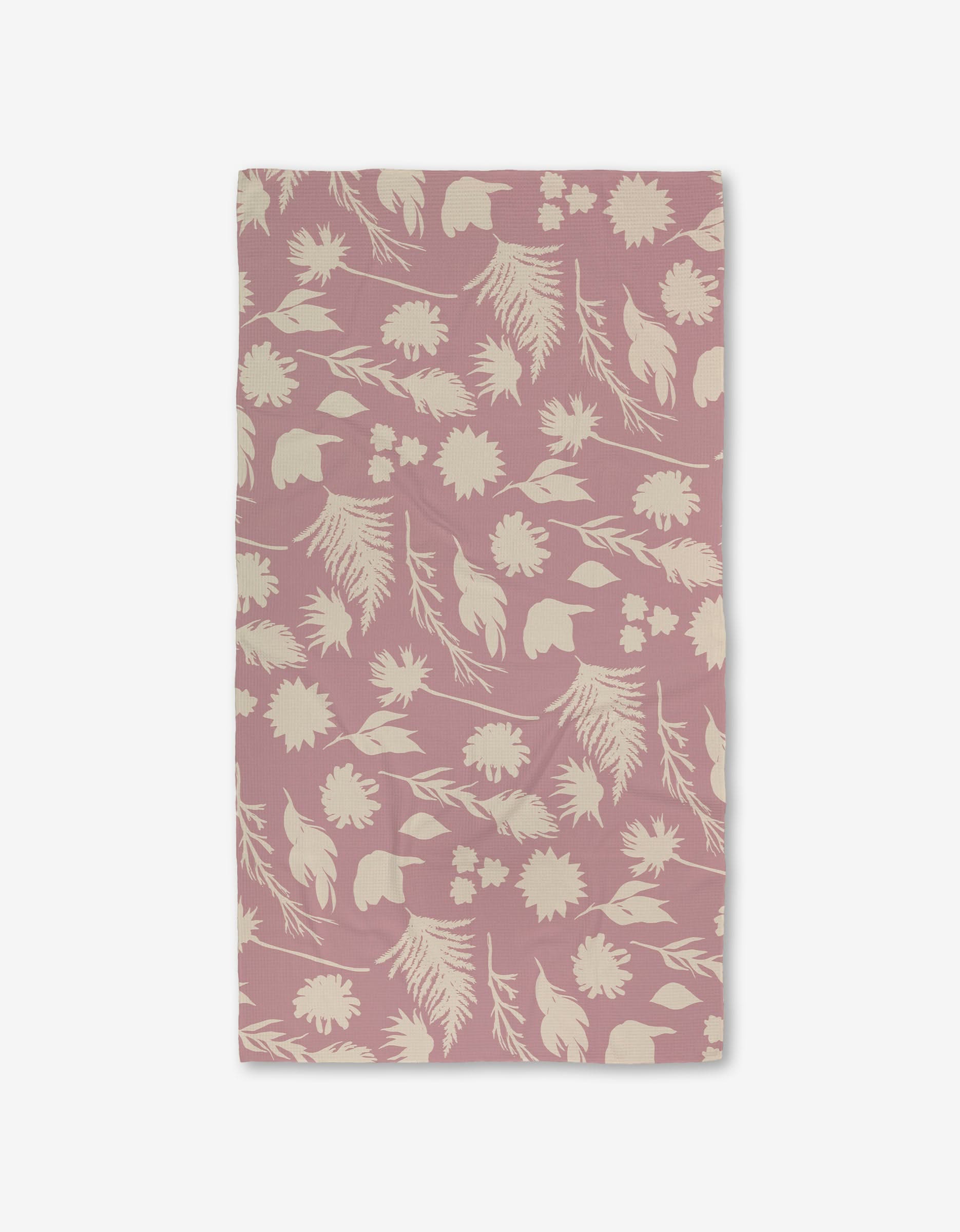 The GEOMETRY Silhouettes Luxe Bath Towel features a pale pink background with a cream floral and leafy design. Made with Geoweave technology, it’s ultra-absorbent, soft, and offers a stylish botanical look.
