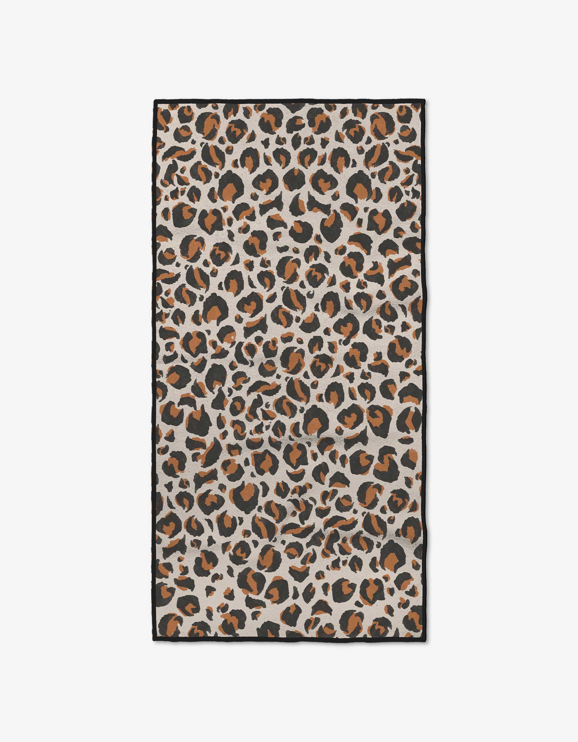 The GEOMETRY Leopard fitness towel is rectangular and ultra-absorbent, made from recycled materials, and features a bold leopard print with black, brown, and tan spots on a light beige background.