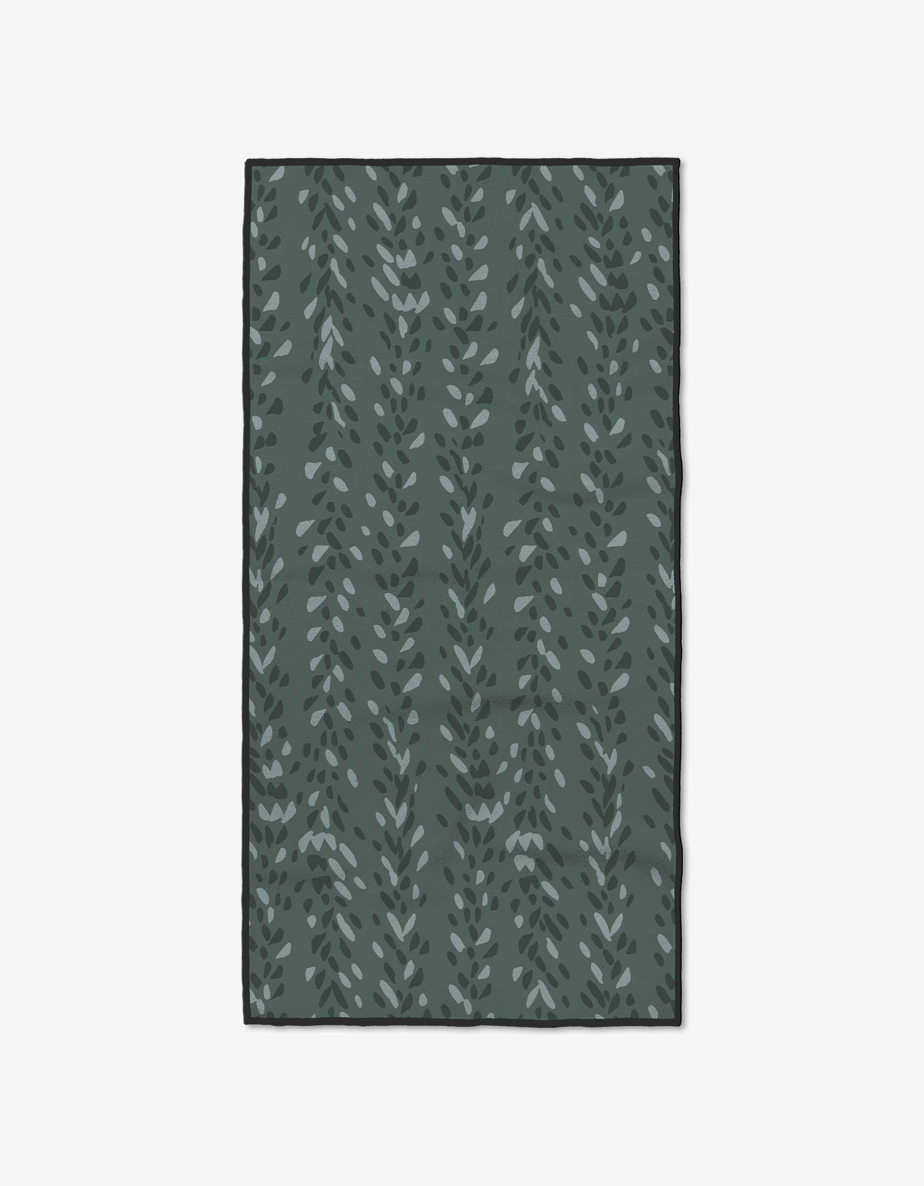 The GEOMETRY Pose rug is a rectangular green rug made from recycled materials, showcasing vertical leafy vine patterns in multiple green shades against a plain white background.
